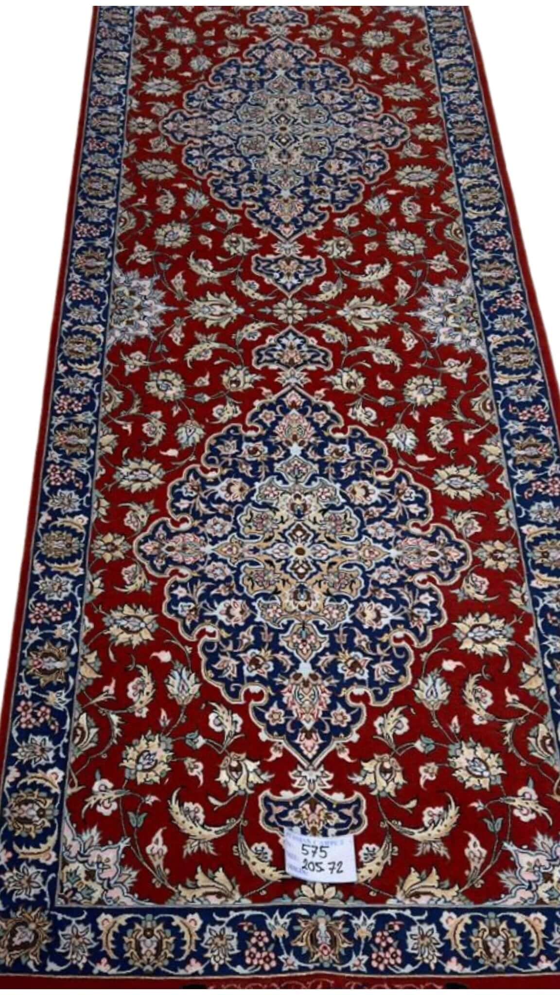 "Handcrafted red Persian rug runner with silk warp and floral medallion design, made in Isfahan by Karbasi Zadeh"