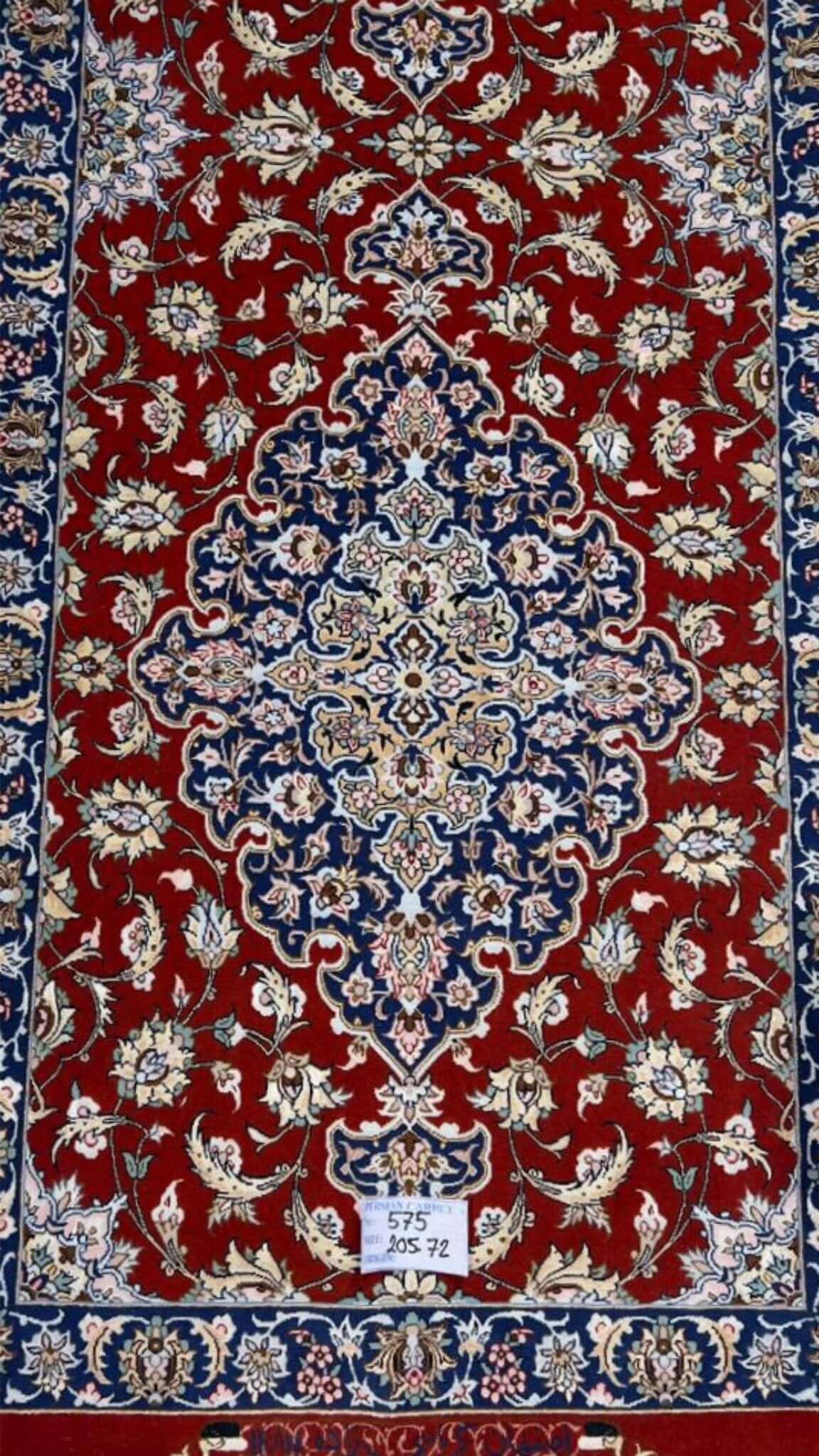 "Close-up of intricate floral pattern on red oriental rug runner from Isfahan"
