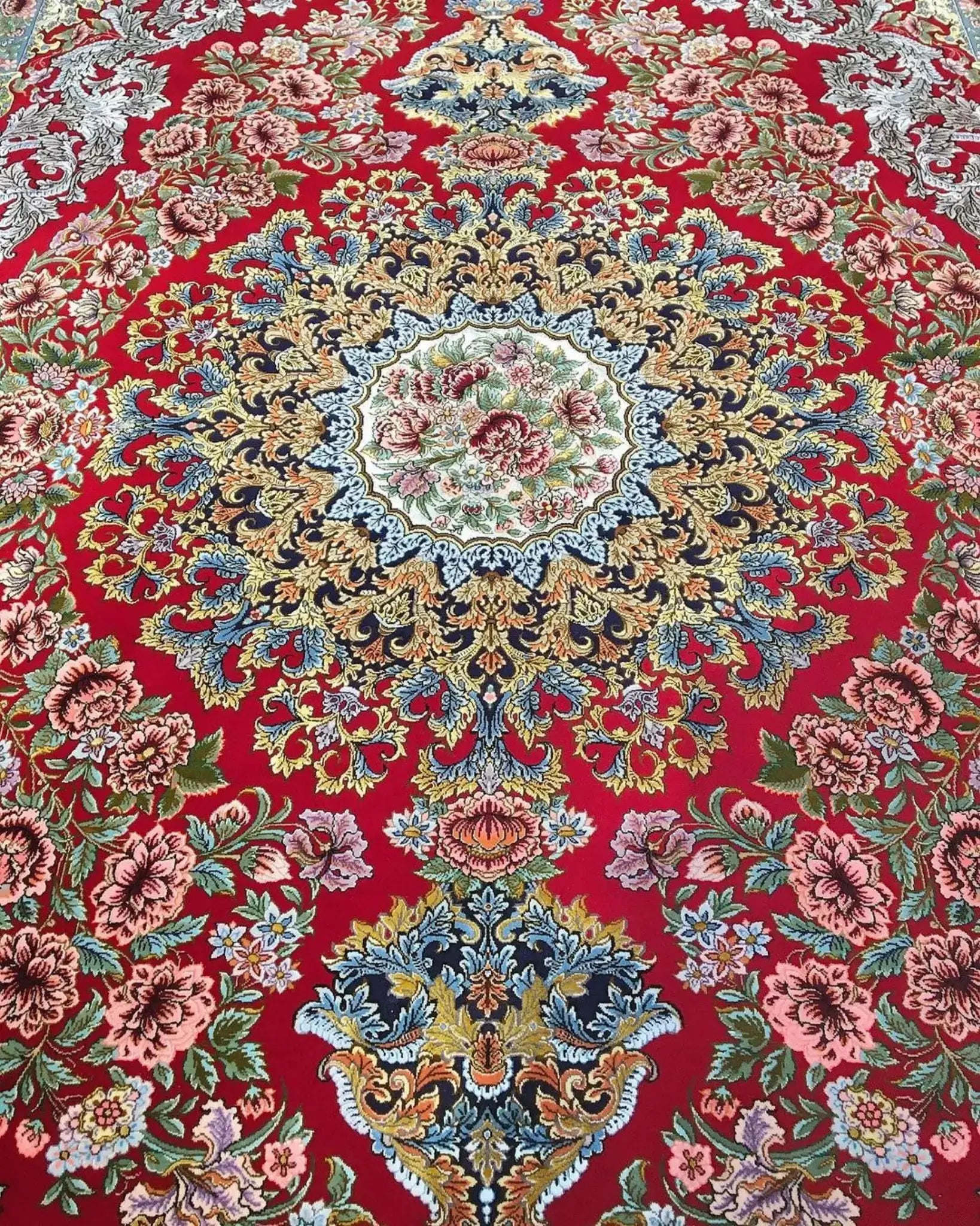 Persian rug for sale featuring floral patterns and luxurious wool and silk materials
