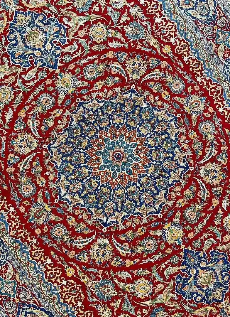 Detailed view of the Isfahan Persian carpet's central medallion in red and blue