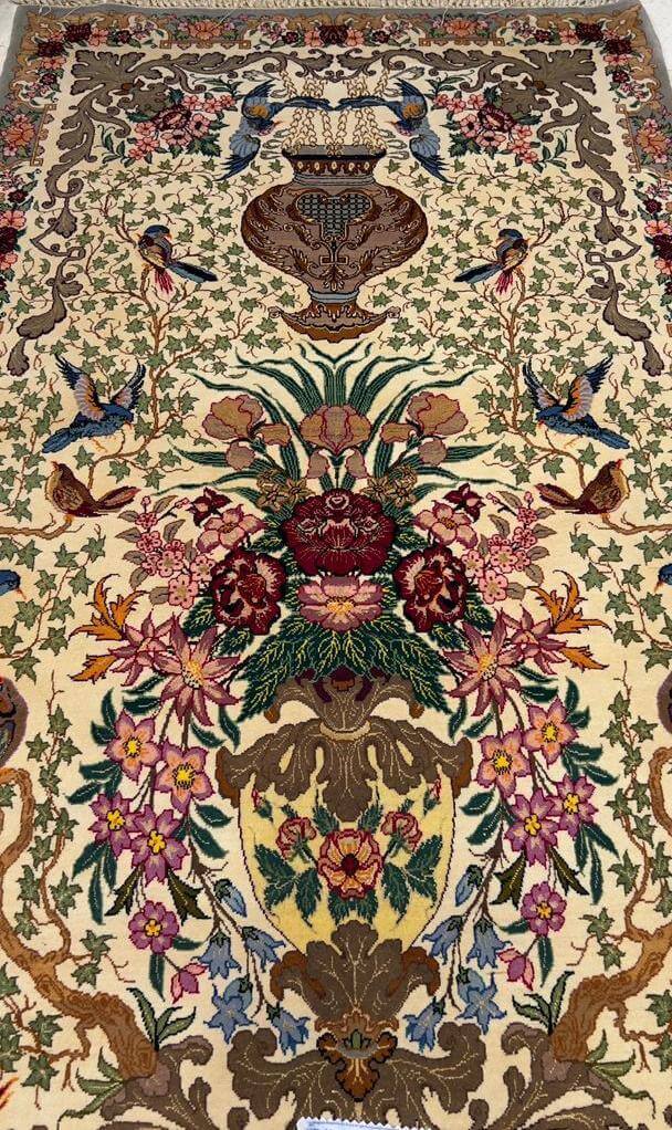 Close-up of the detailed floral craftsmanship on the luxury hand-knotted rug