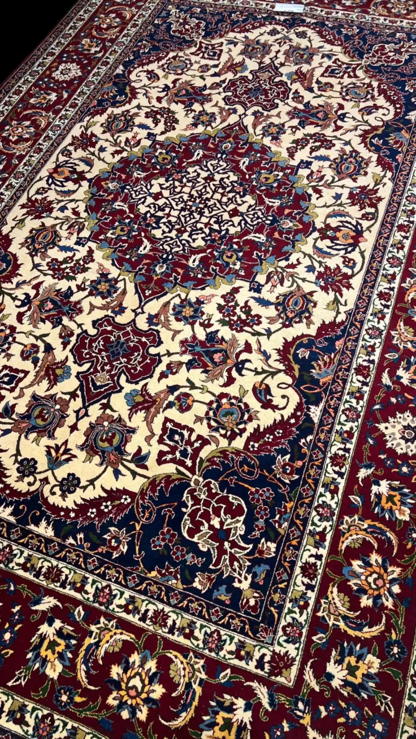 "Hand-knotted Persian rug in red and ivory with intricate floral design, crafted from wool and silk. Luxury oriental rug from Isfahan, Iran, featuring 1,000,000 knots per square meter for elegant, durable decor."

