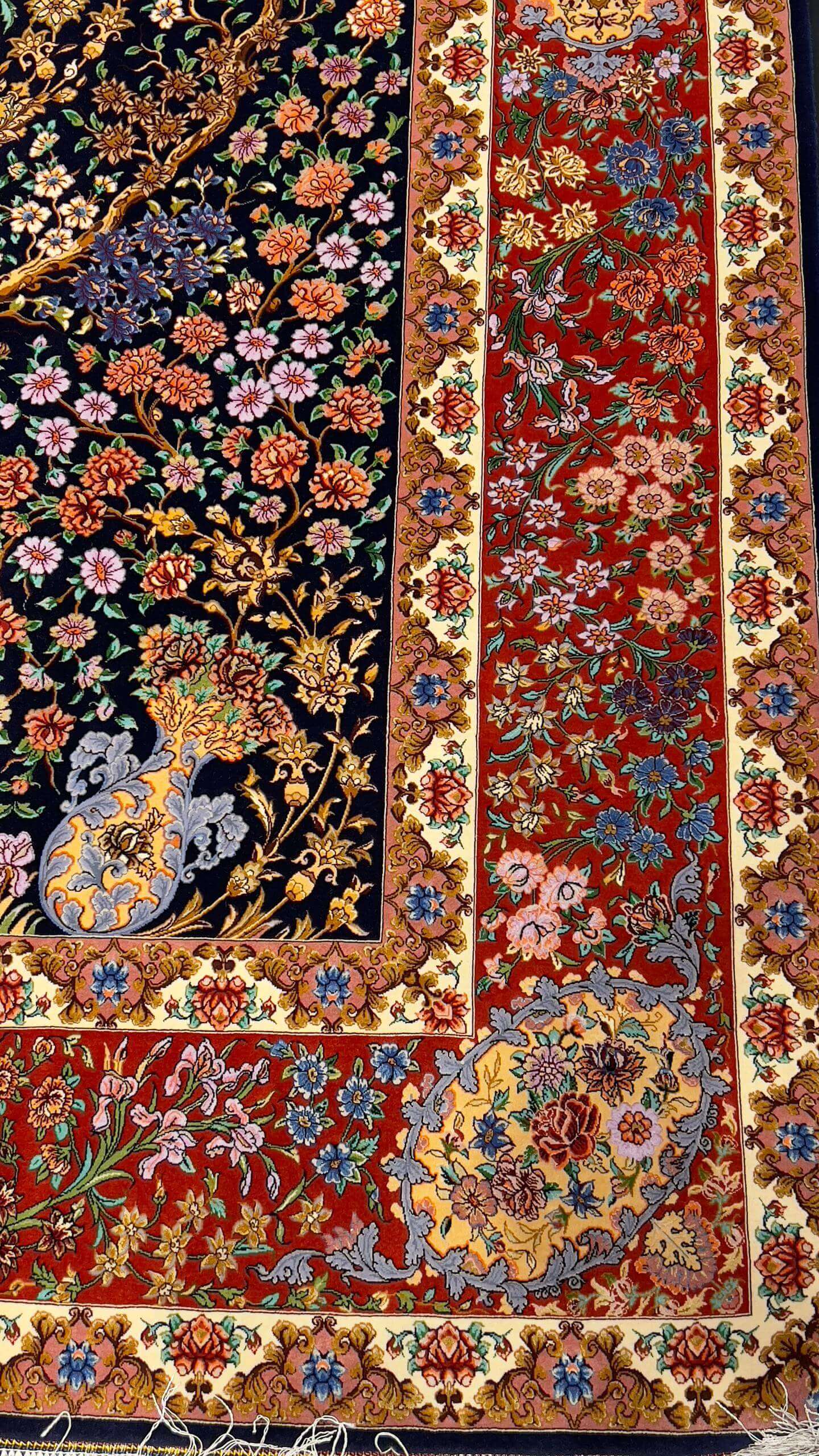 Floral and fauna patterns woven into the fabric of an Isfahan Bartarian Persian rug