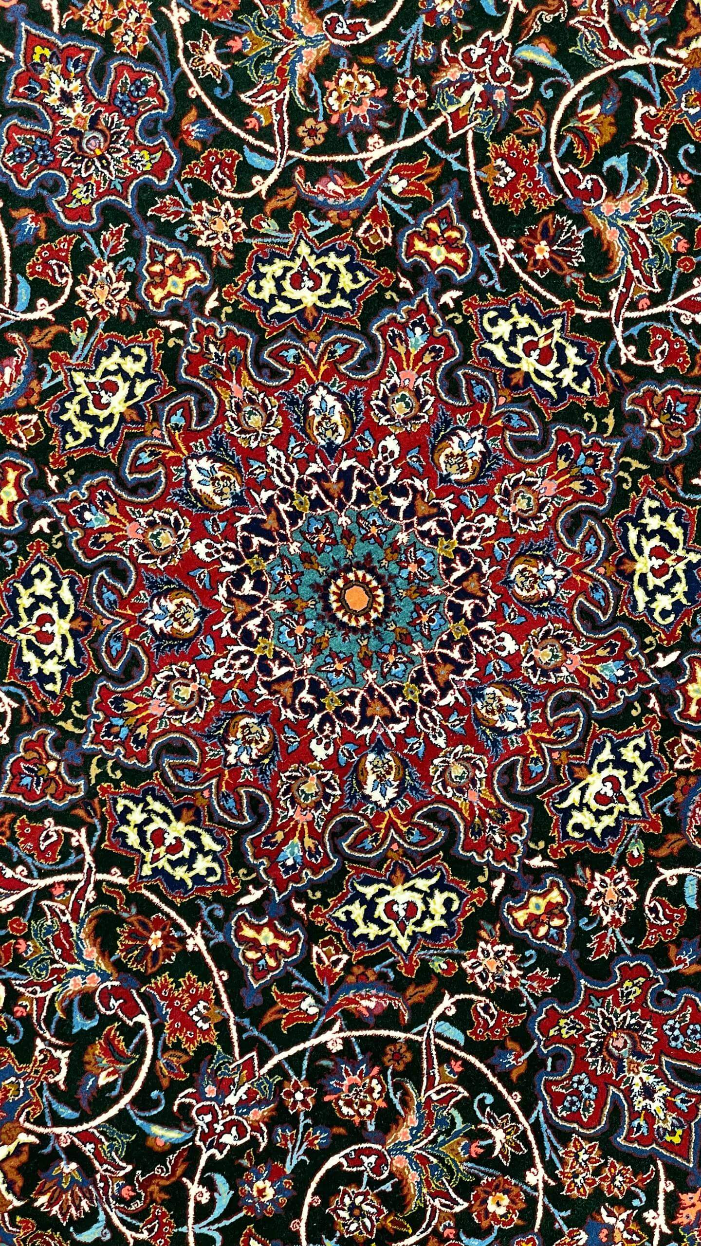"Folded view of the Seirafian carpet highlighting the silk warp and texture."
