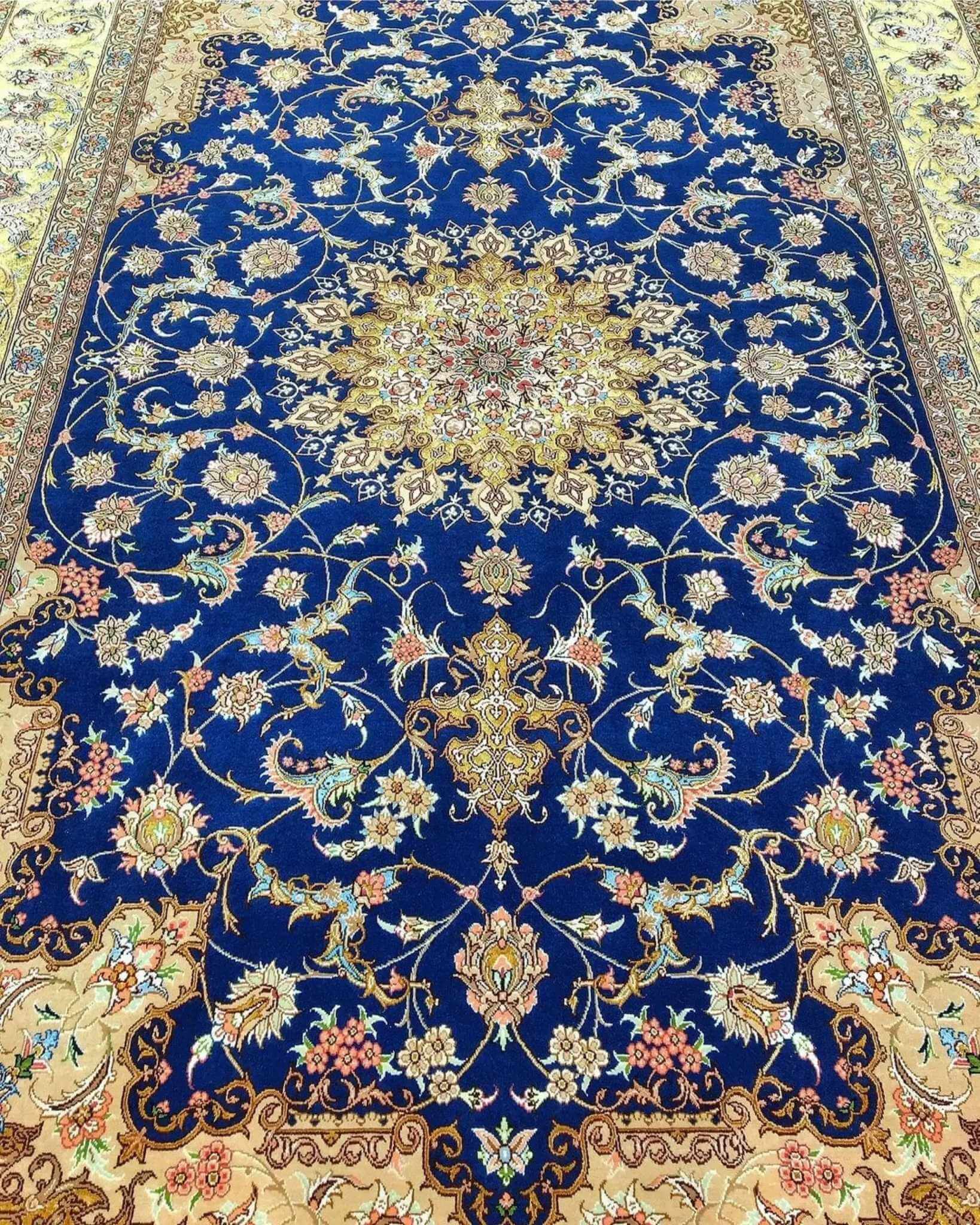 "Luxury Persian carpet featuring deep blue and gold hues, handwoven in Isfahan with silk and wool blend."