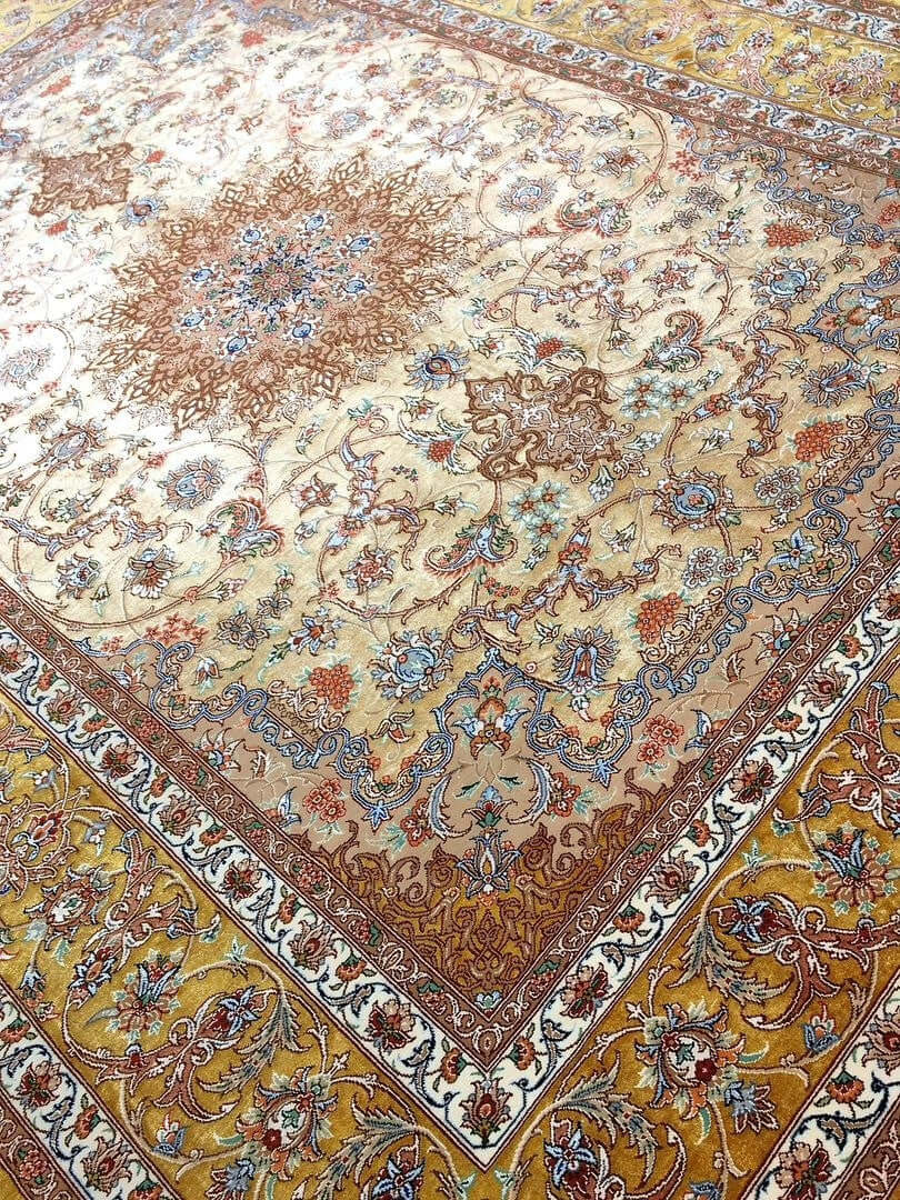 "Authentic Isfahan Persian rug with silk warp and a golden floral medallion, handwoven by Master Mohaghegh."
