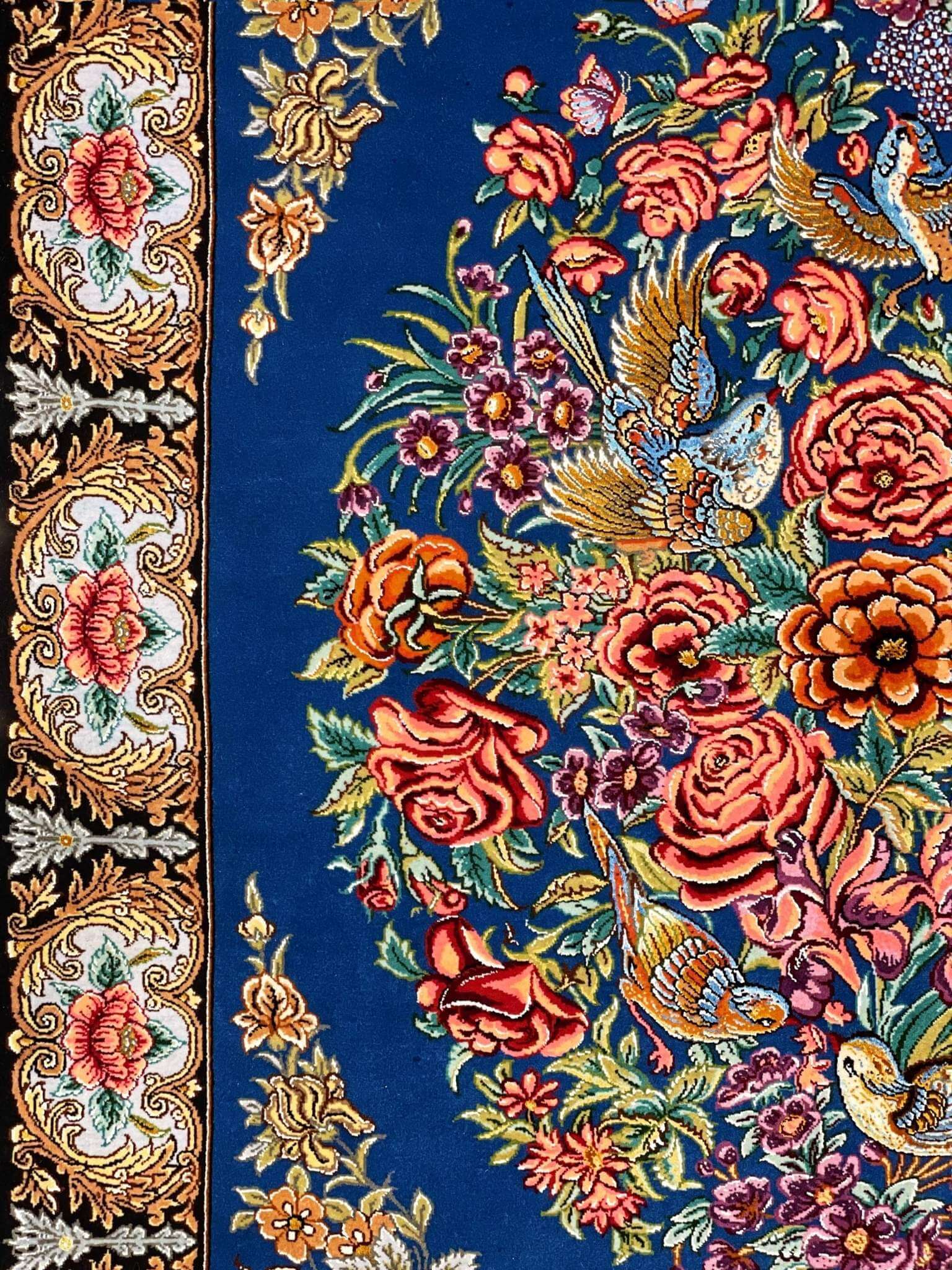 "Authentic Isfahan silk Persian rug with black floral border, golden roses, and a detailed bird and flower pattern."