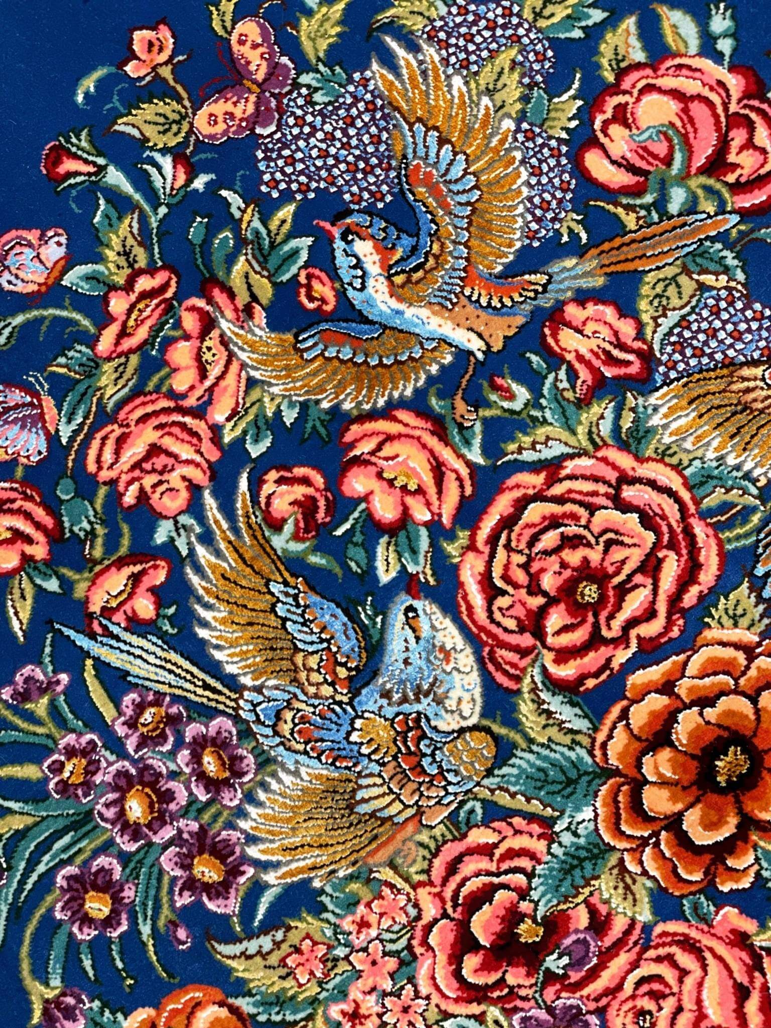 "Exquisite handmade Persian carpet with vibrant floral motifs, master craftsmanship, and a luminous silk finish."