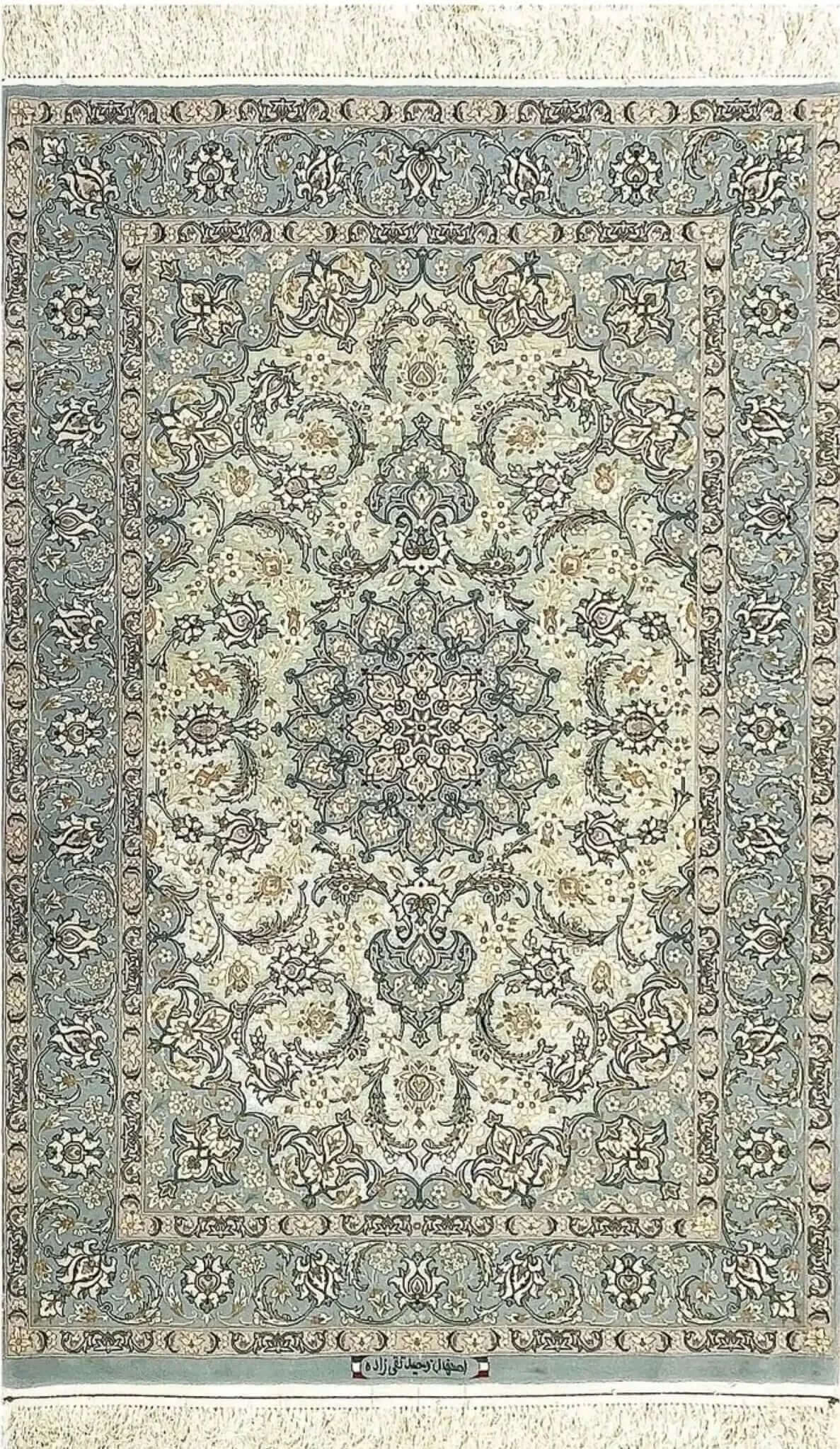 "Handmade Isfahan Persian rug with intricate floral medallion, crafted from fine silk and wool in soft blue and ivory."