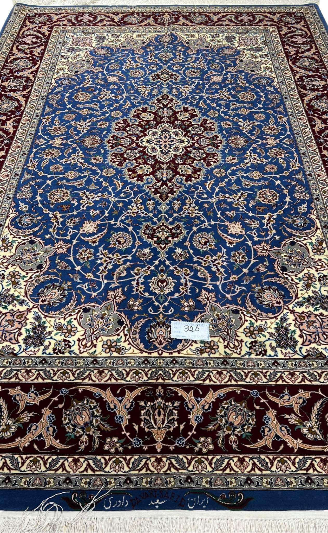 "Luxurious hand-knotted Persian carpet from Isfahan, Iran, with intricate floral motifs and silk highlights."
