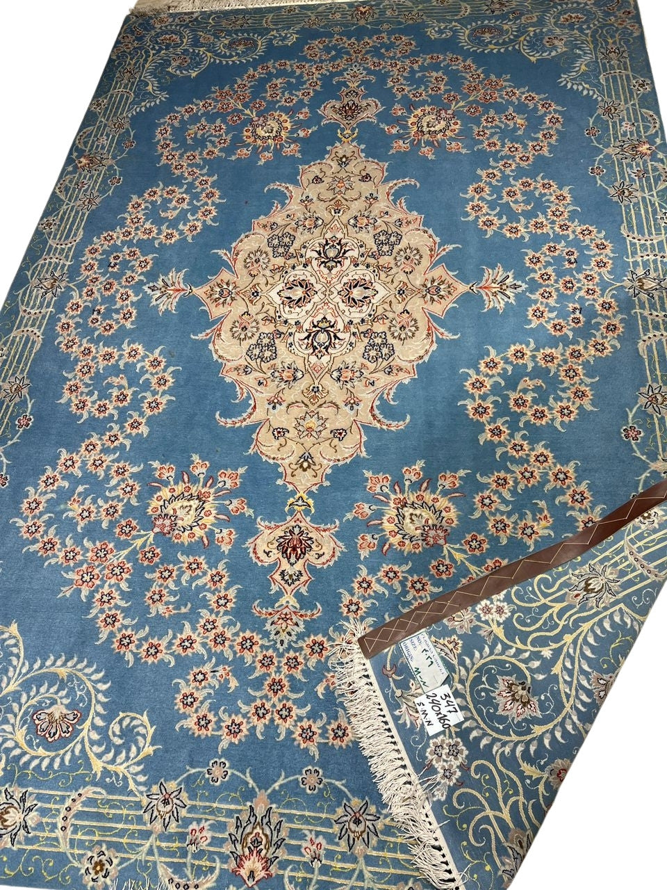 Elegant silk and wool Isfahan carpet with a central medallion design.
