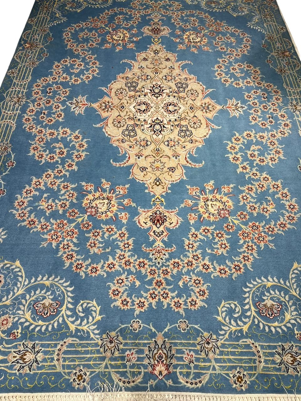 Sky blue Isfahan Persian rug with central cream medallion and floral motifs.
