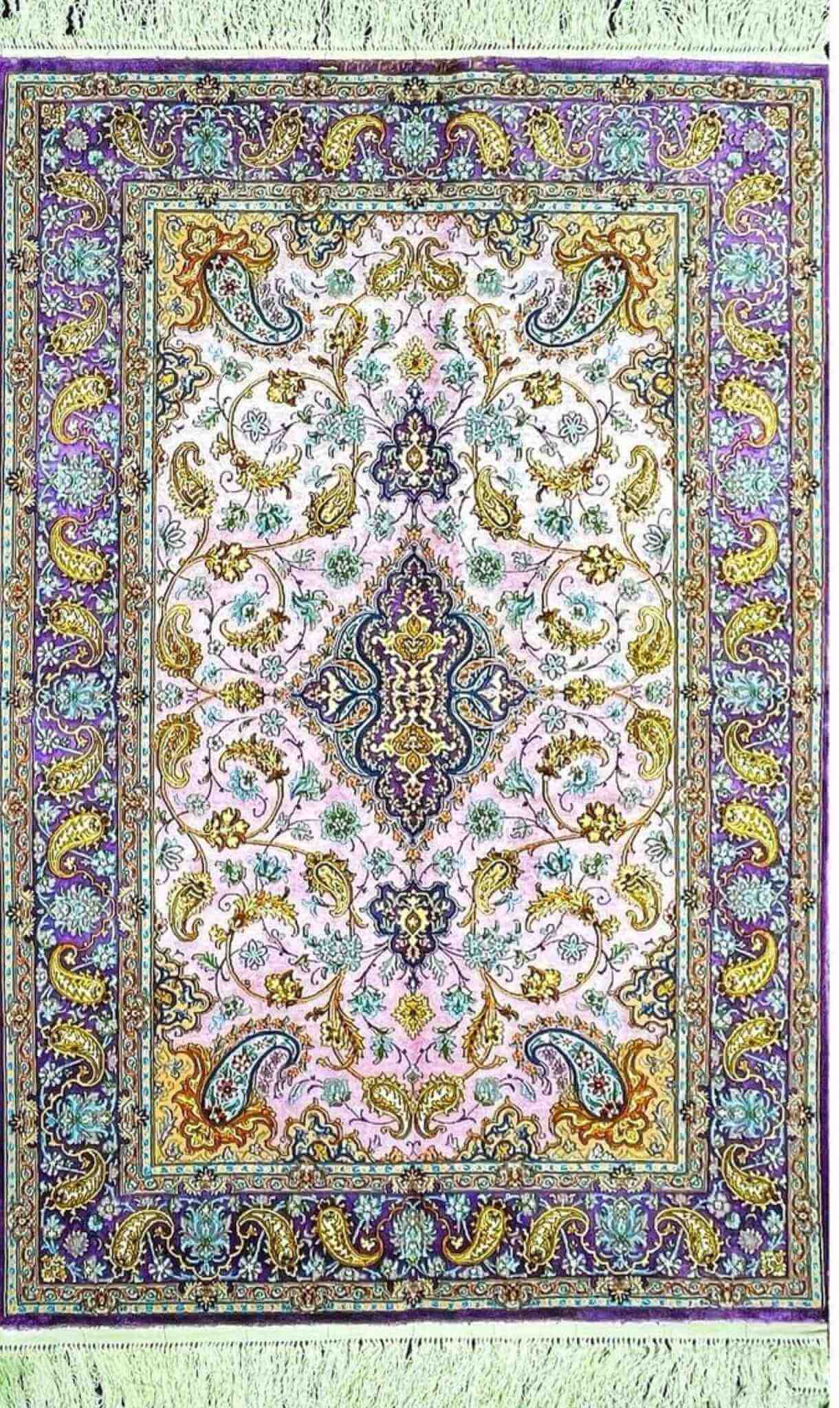 "Hand-knotted Isfahan silk Persian rug with pink and purple floral medallion design."