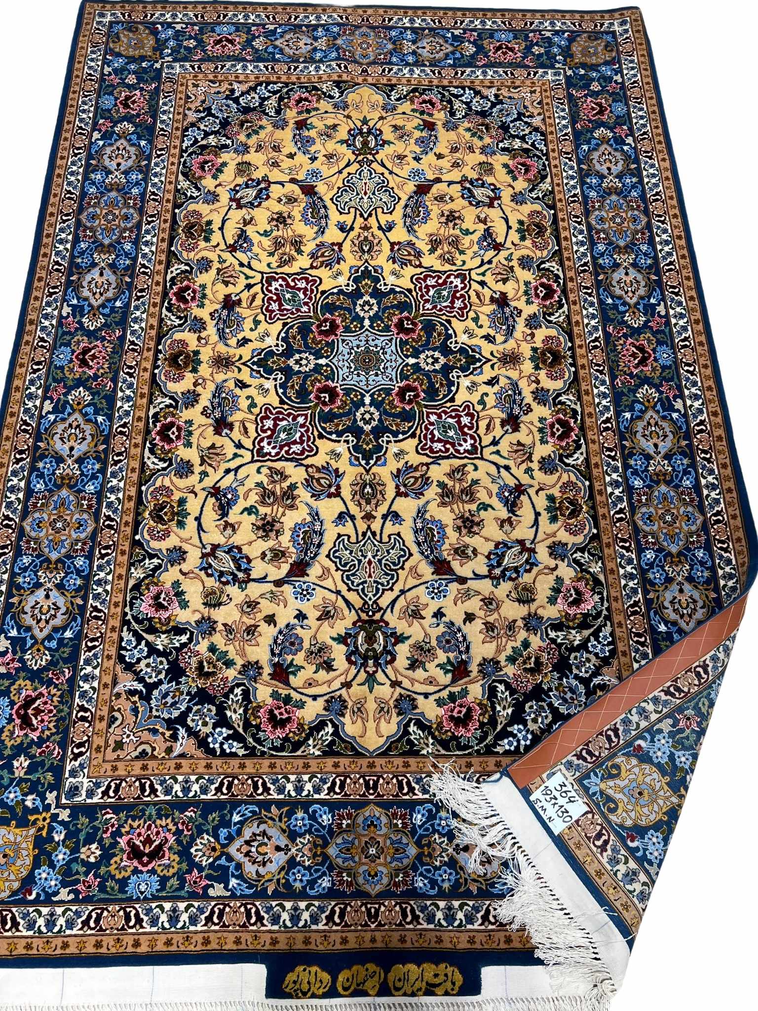 Floral patterned Persian rug with a golden medallion design.