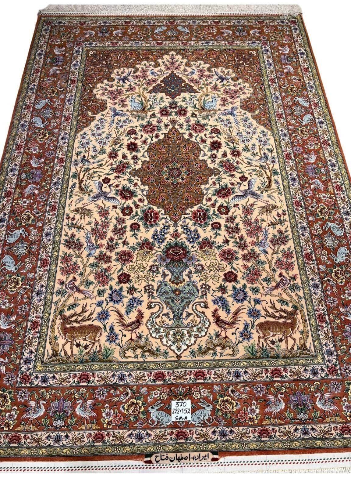 "Handmade Persian rug with intricate deer and bird motifs, traditional Persian floral designs, and silk detailing."