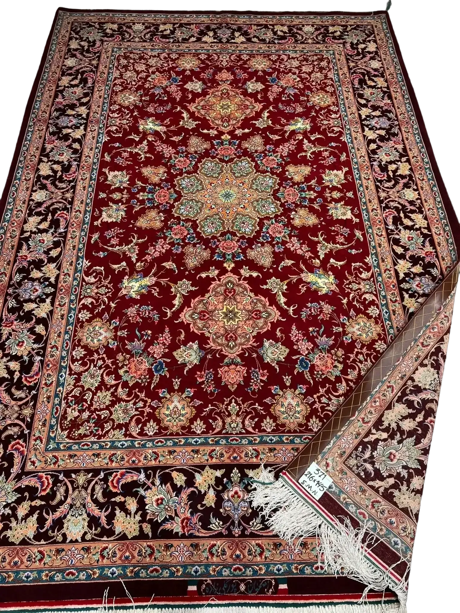 A detailed floral pattern on an Isfahan Persian rug with red and black hues