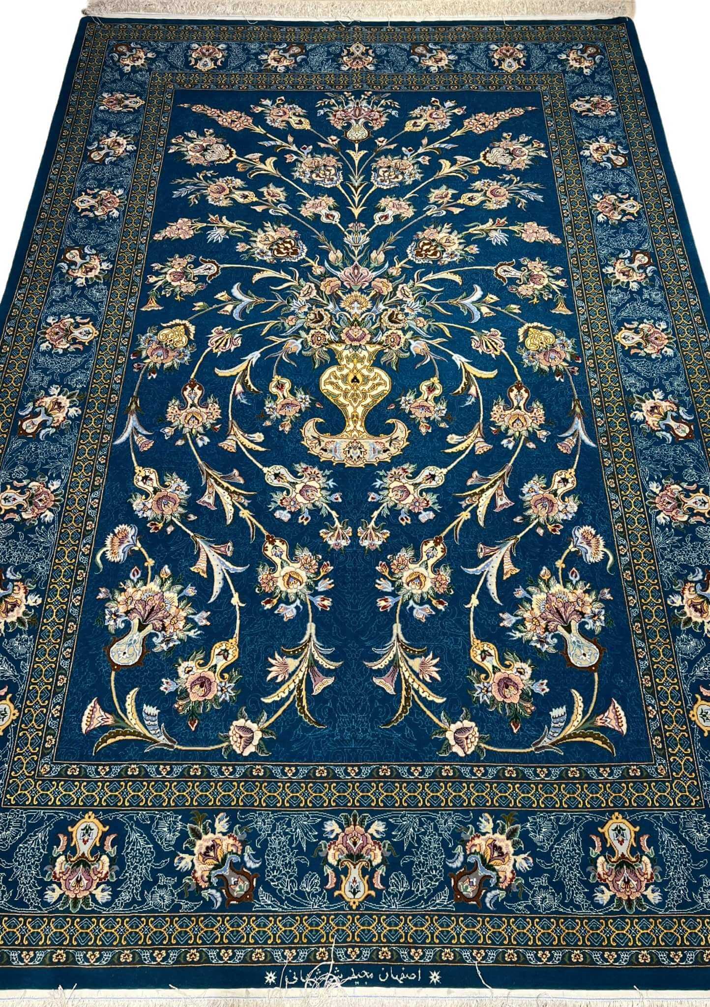 Luxurious hand-knotted Isfahan rug with navy blue floral vase design.
