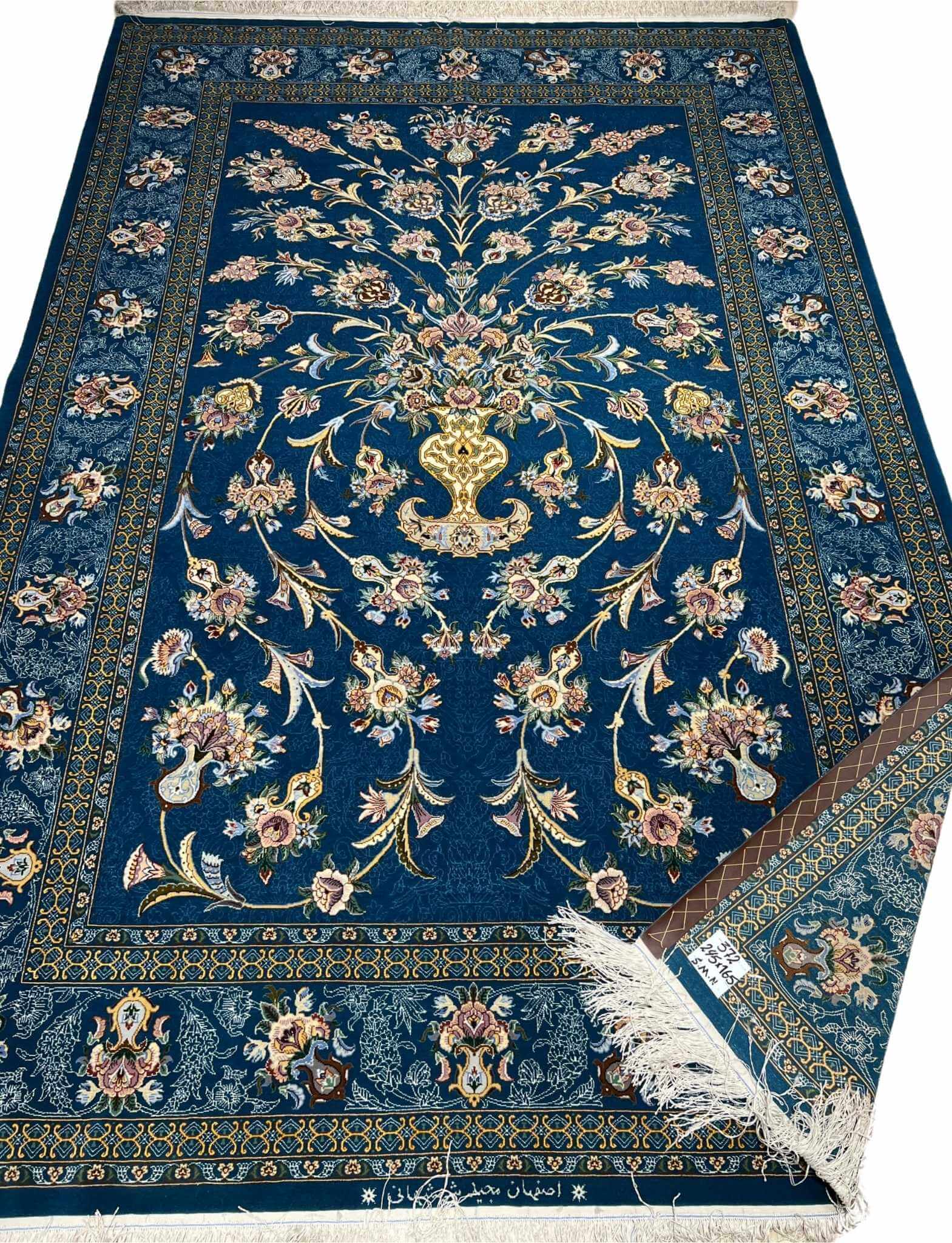 Persian wool and silk rug featuring a central floral motif by Shahshani.
