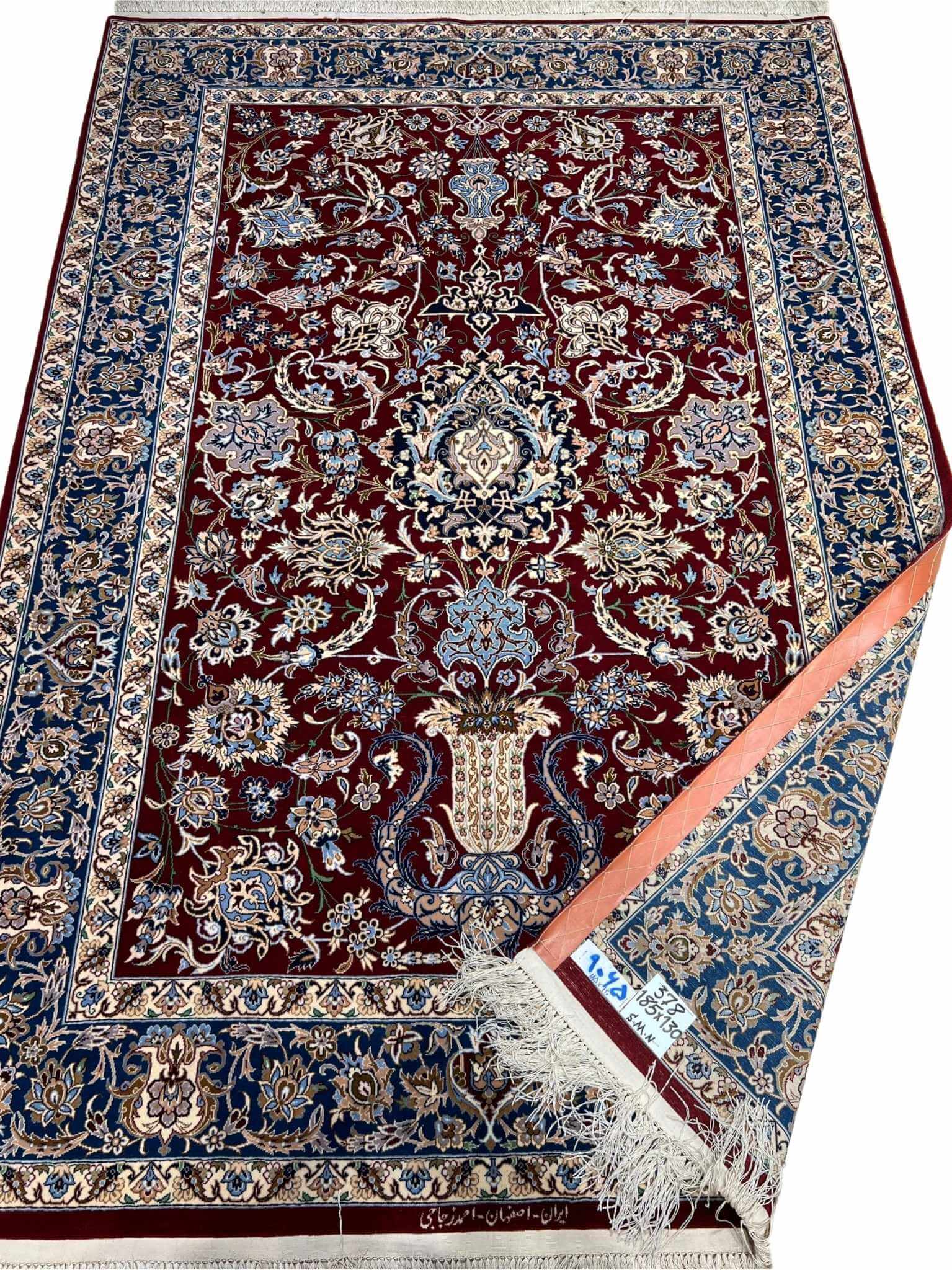 Premium dark red Persian rug with detailed floral artwork on display