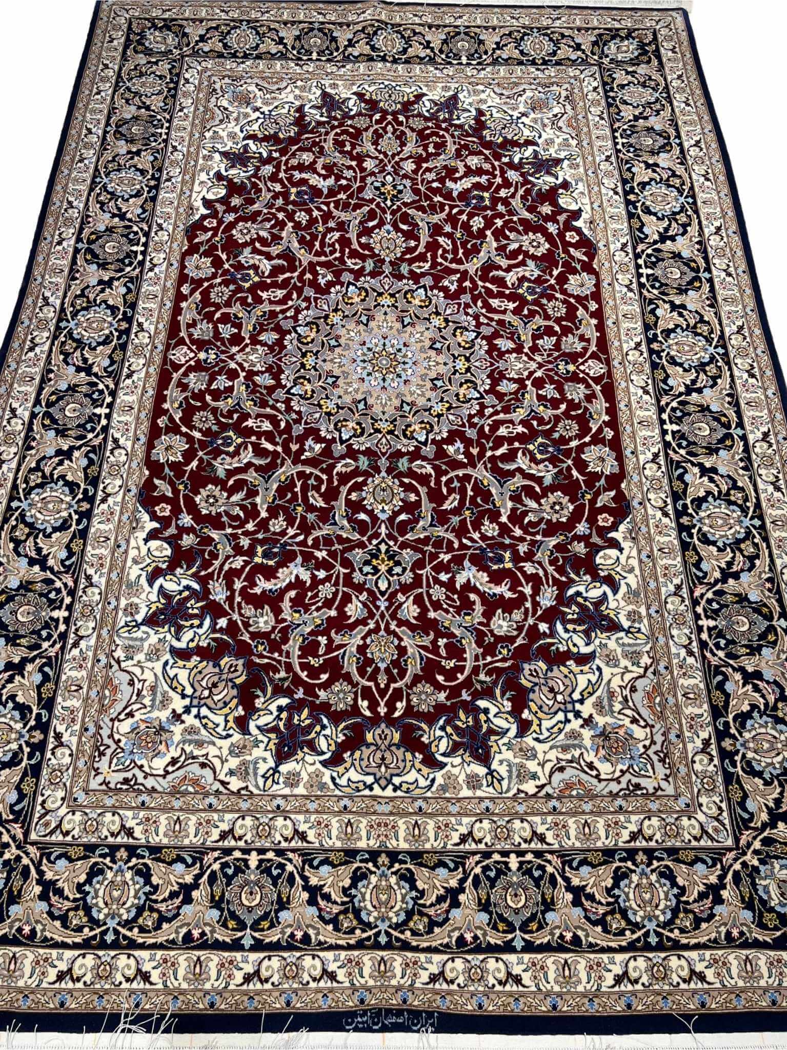 Persian Isfahan rug with deep crimson red and ivory floral design.

