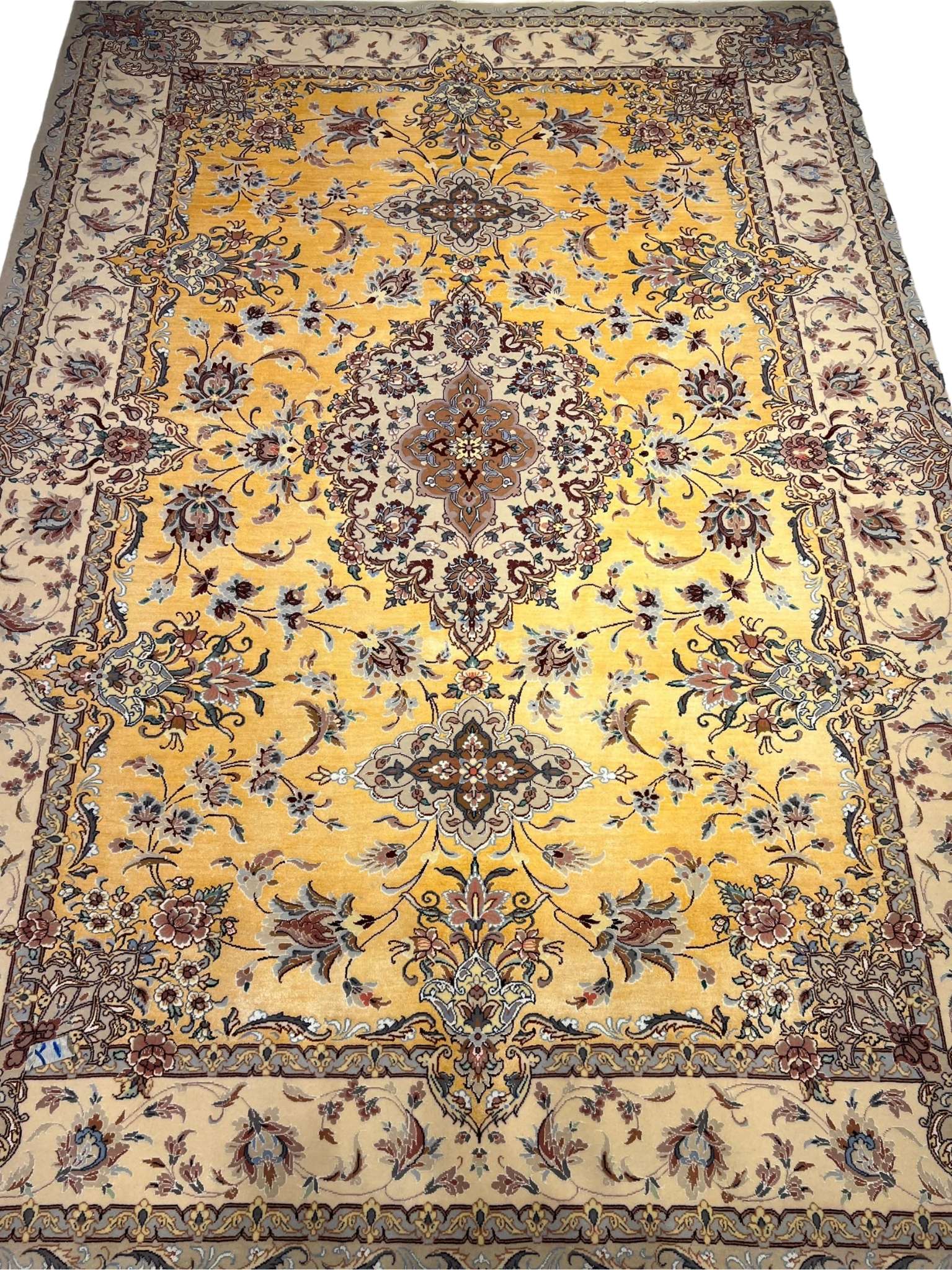 Spacious oriental-inspired silk rug in shades of gold and beige