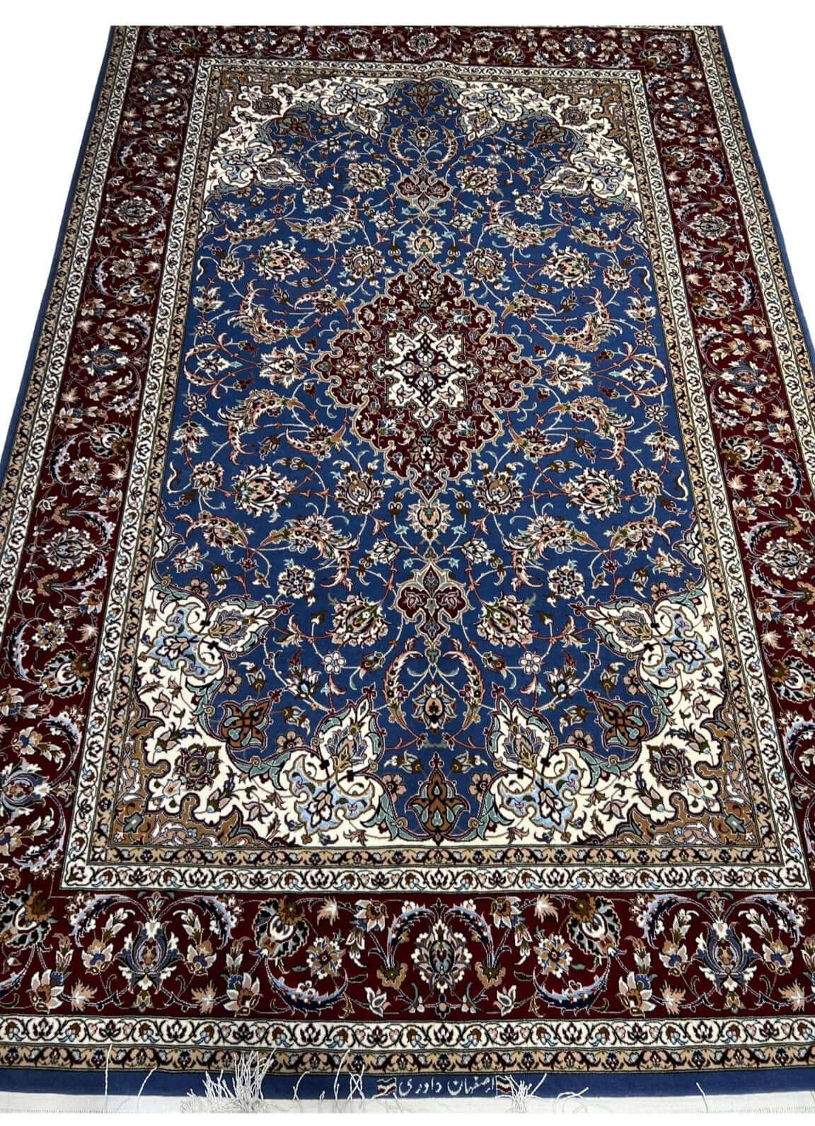 "Knotted wool and silk Persian rug with intricate floral and geometric patterns from Isfahan."
