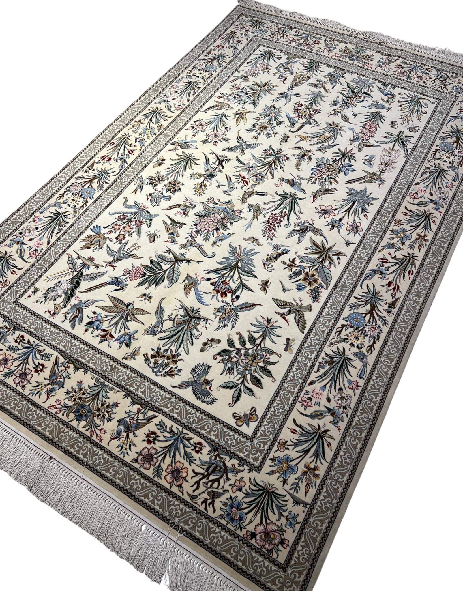 "Exquisite silk and wool Persian carpet – luxury hand-knotted Isfahan rug with natural bird and floral patterns."