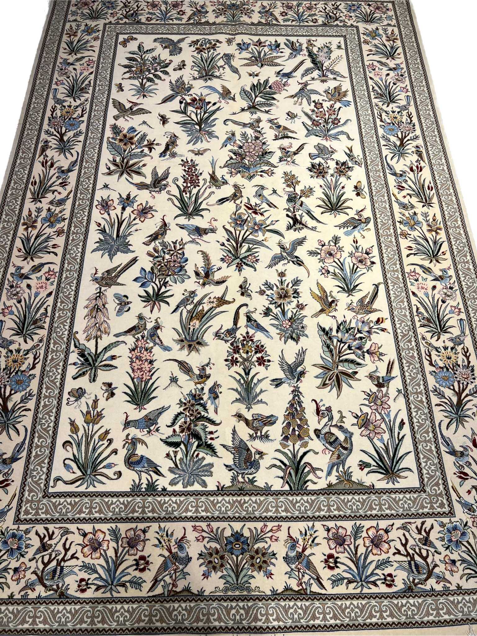 "Handmade Isfahan Persian rug with floral and bird design, crafted from silk and wool for a luxurious touch."