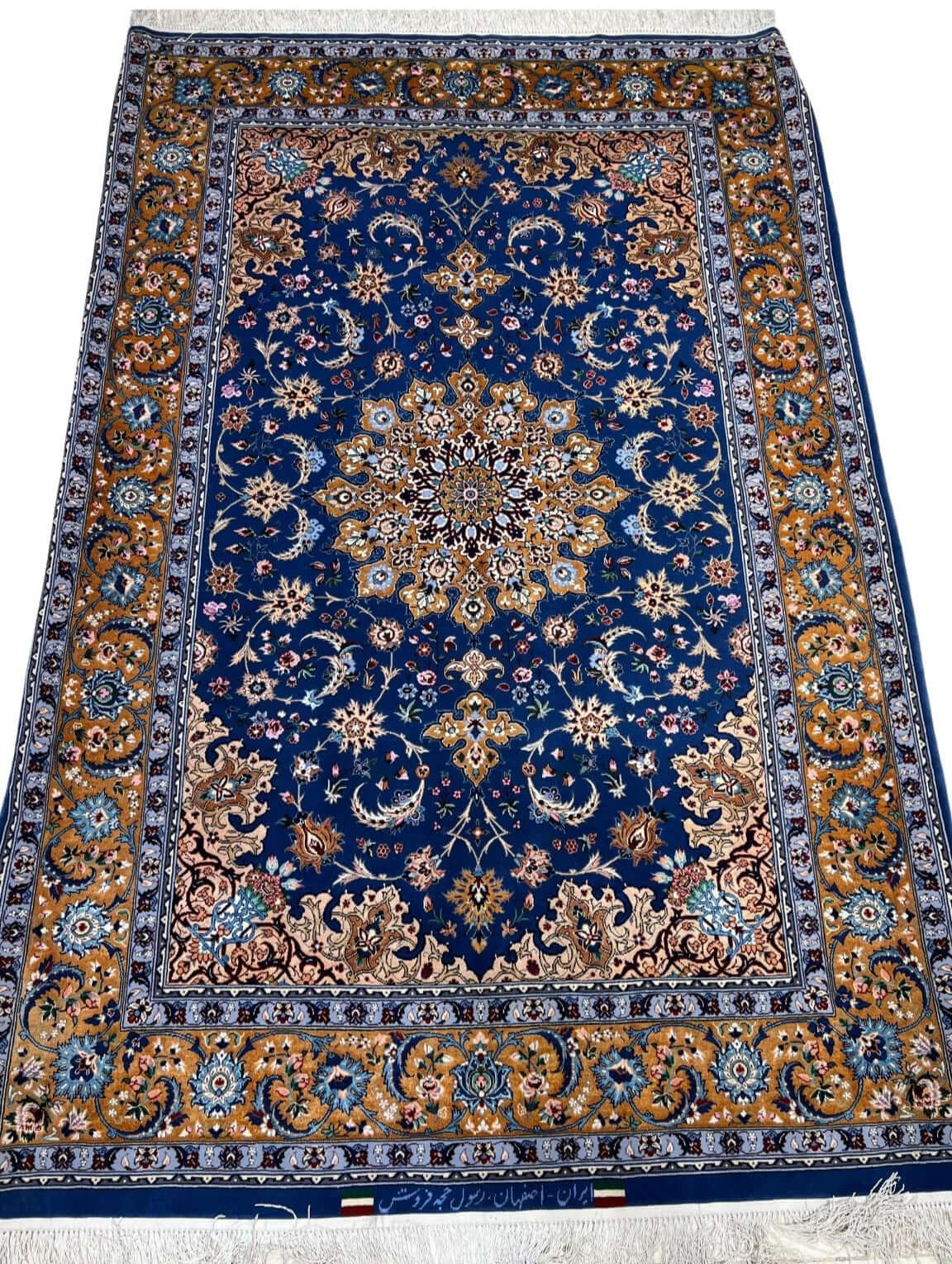 "Authentic handcrafted Persian rug from Isfahan with intricate floral and geometric patterns."
