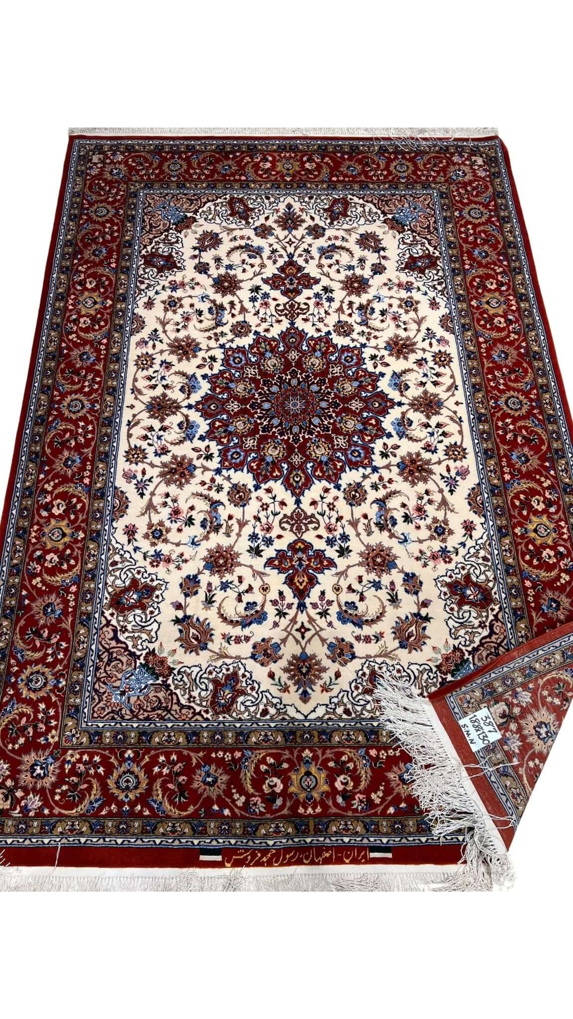 "Isfahan rug with a silk warp and 640,000 knots per square meter, featuring red tones."
