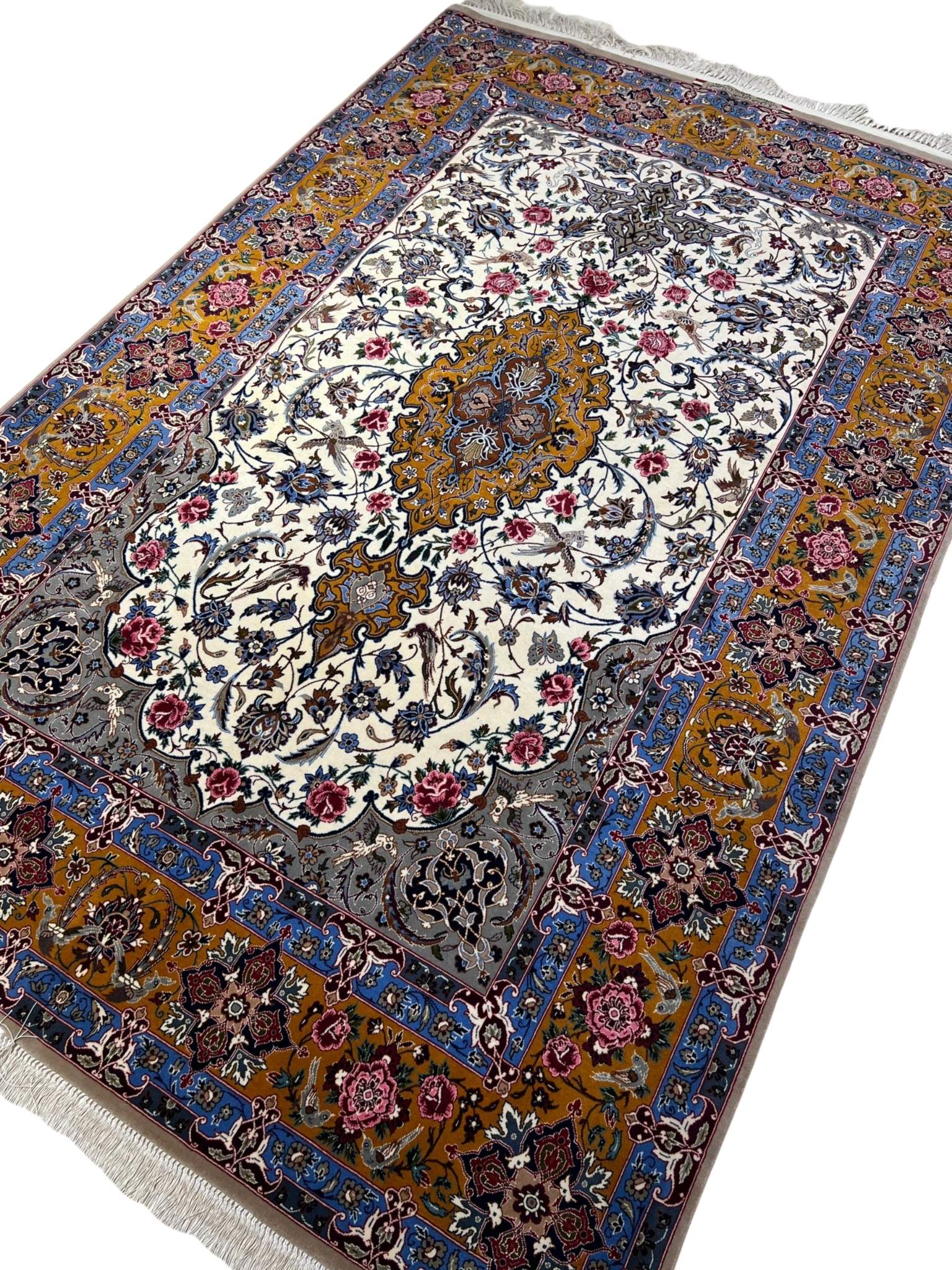 Floral-patterned Persian rug with vibrant borders in golden and blue.
