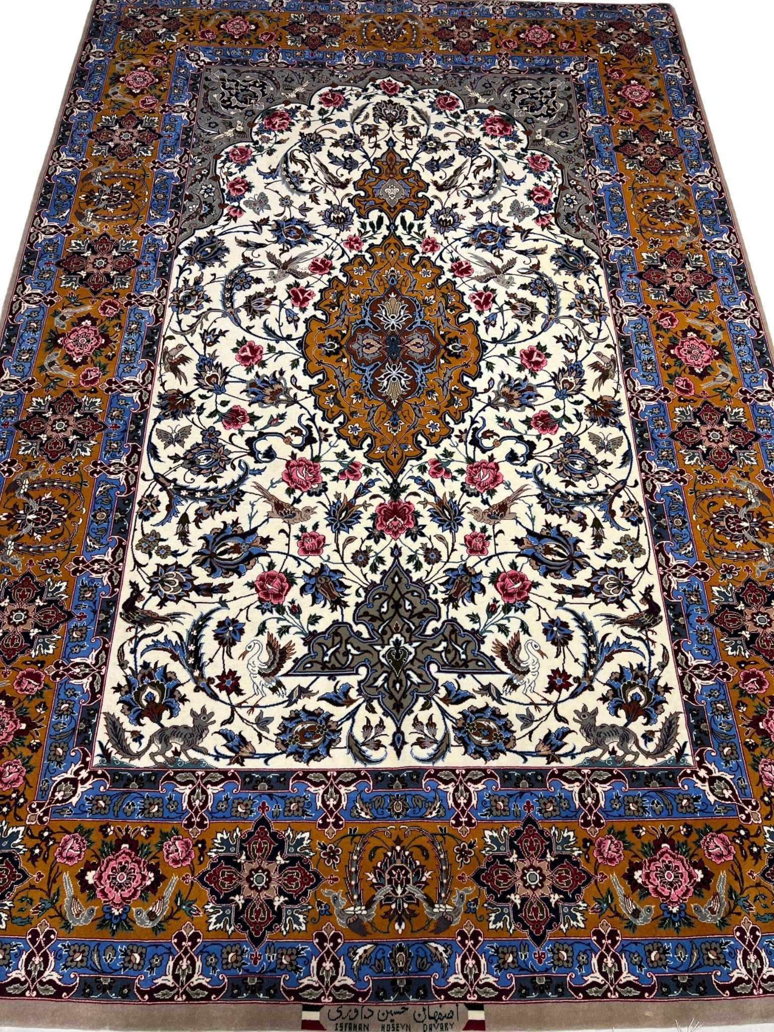 Vintage Isfahan Persian rug with a golden medallion and floral motifs.
