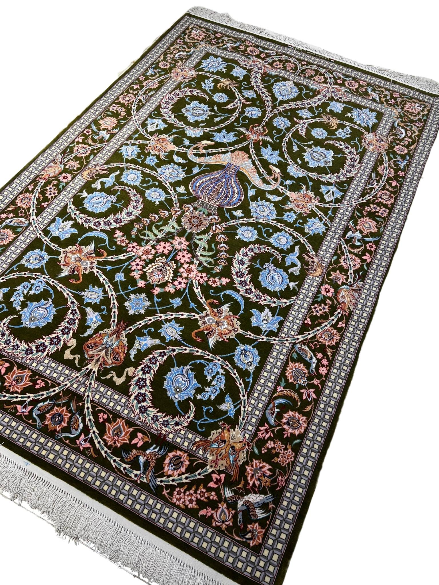 Elegant Isfahan rug featuring blue and pink flower motifs.
