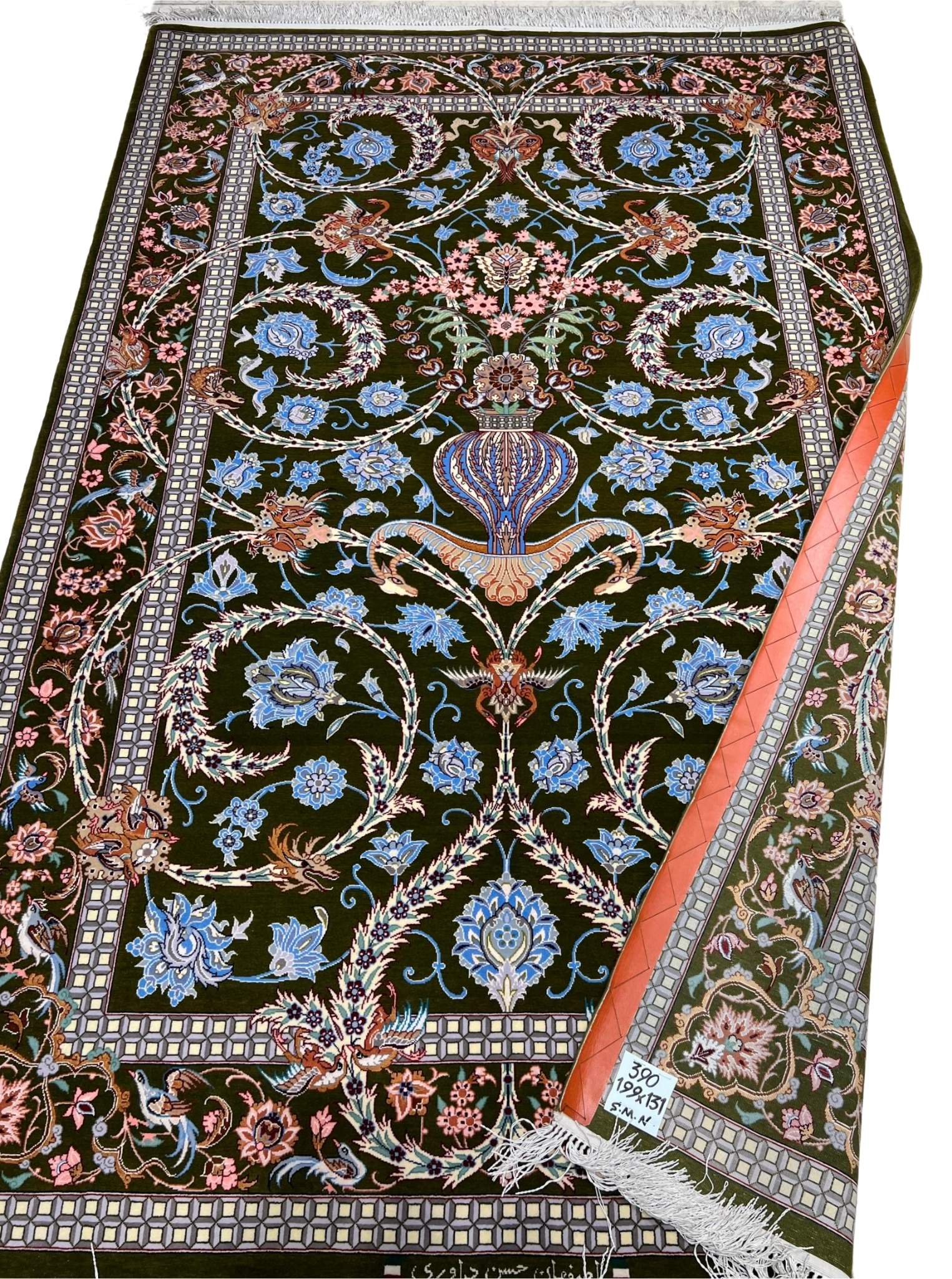 Handwoven Persian rug with intricate floral patterns.
