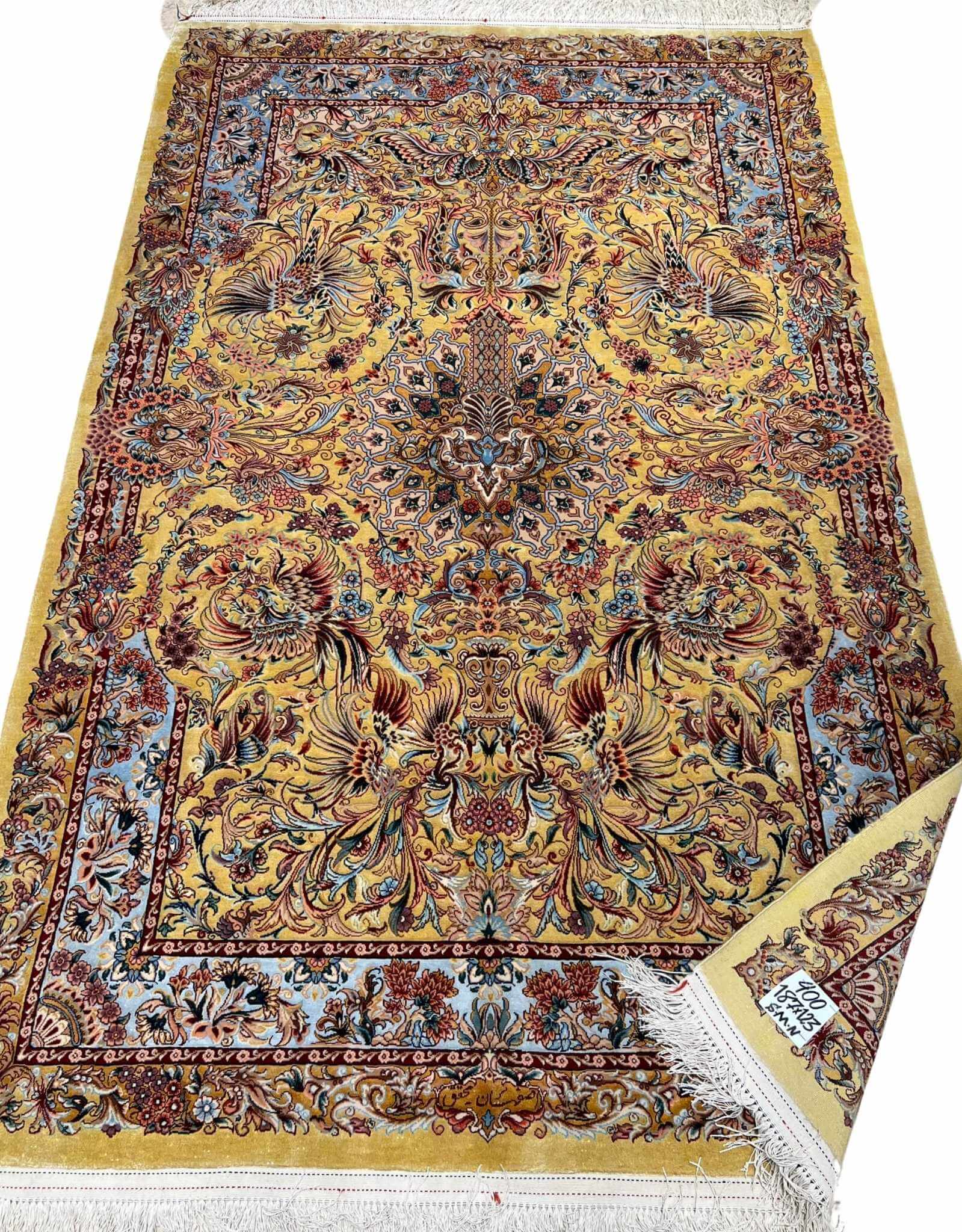 "Luxury Persian carpet with an elaborate golden and burgundy medallion design, hand-knotted in Isfahan, Iran."