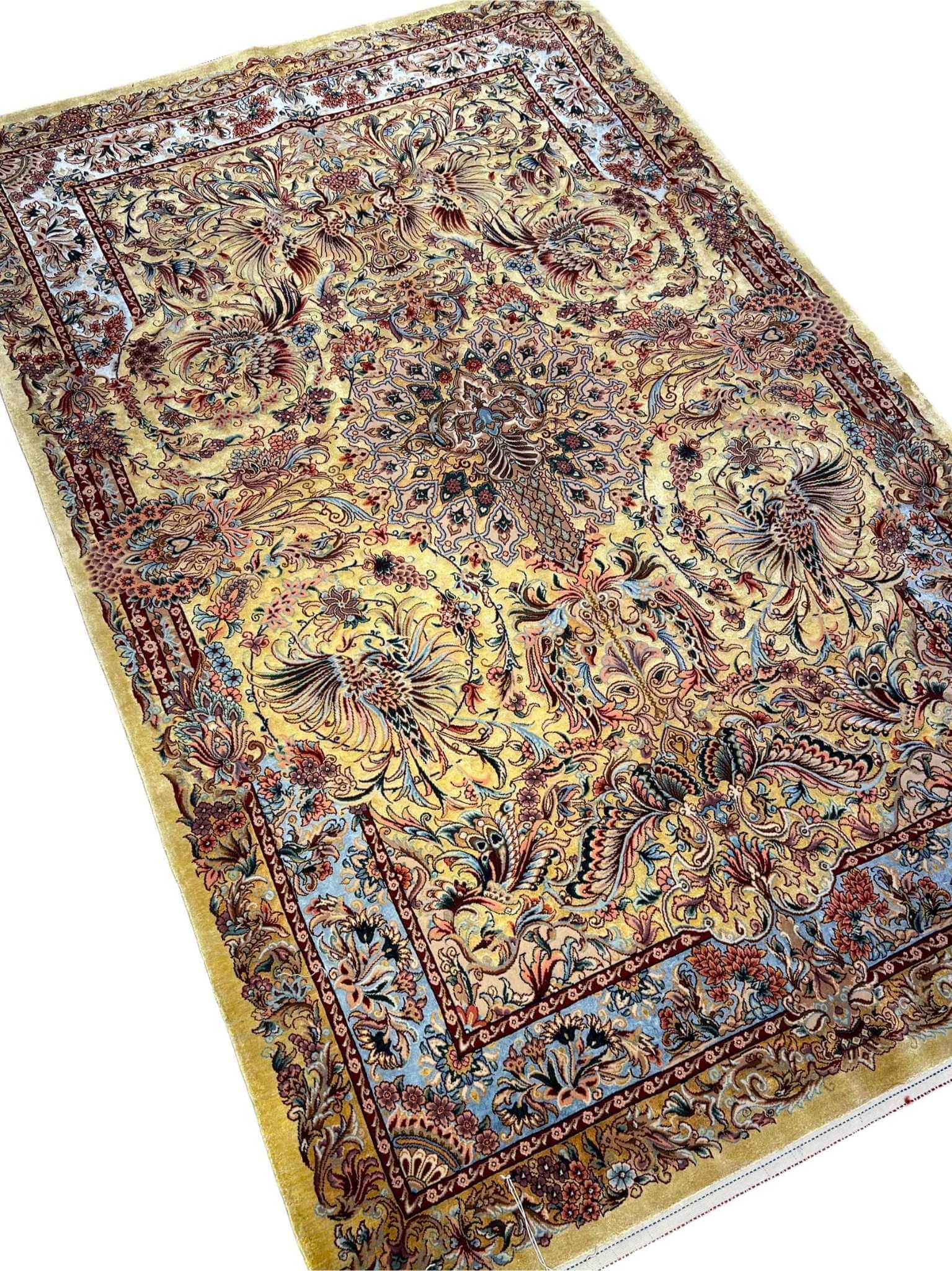"Authentic Persian wool and silk rug featuring a phoenix and floral motif, ideal for elegant interiors and collectors."