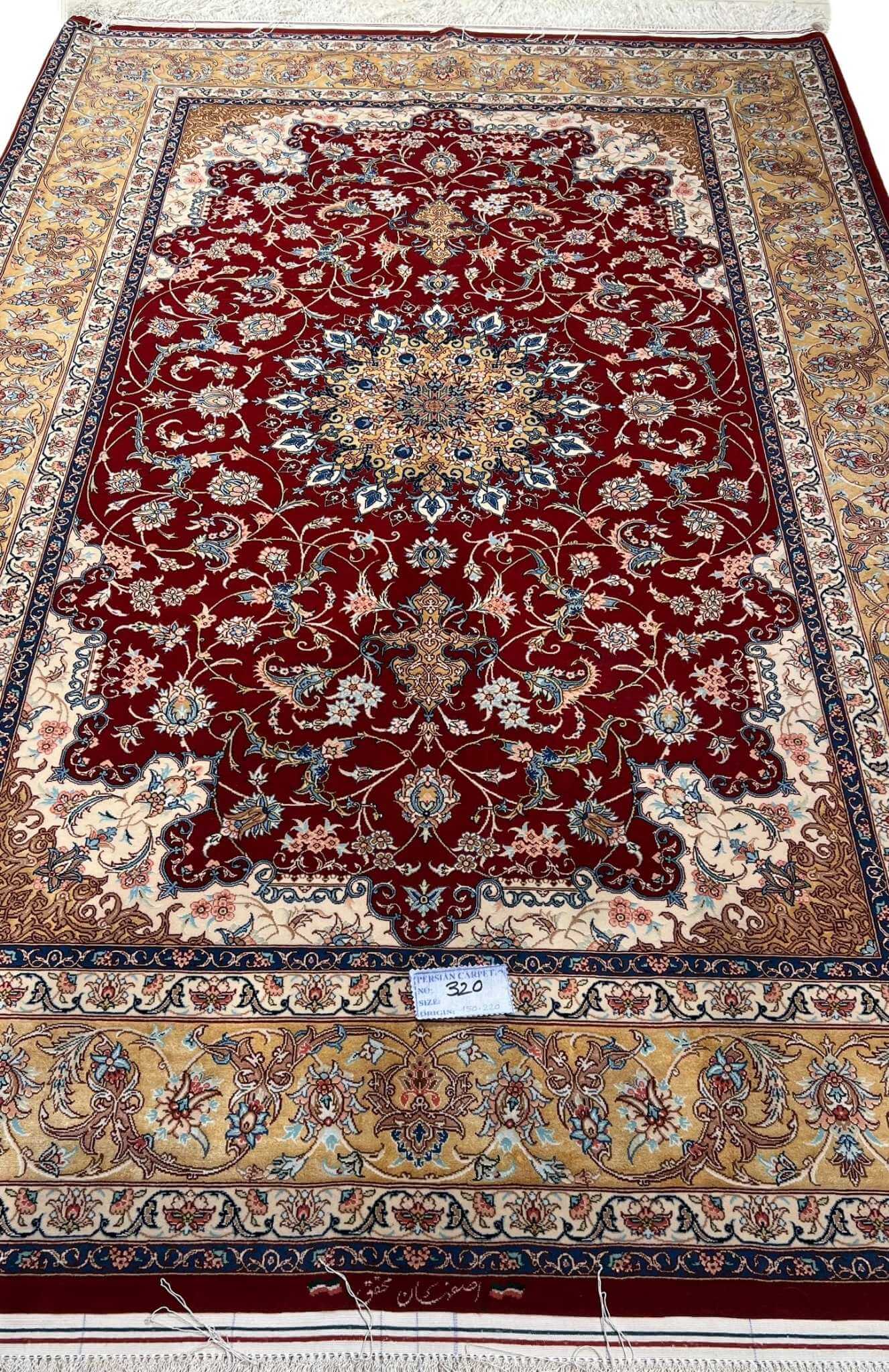 "Luxury Persian wool and silk rug with a classic red and gold design, perfect for sophisticated interiors."