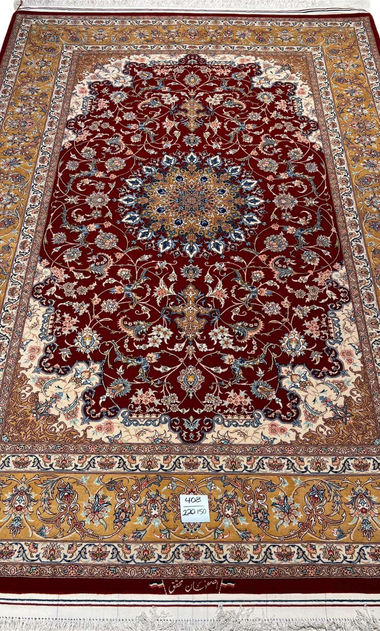 "Handmade Isfahan Persian rug with deep red medallion design, crafted from silk and wool for a luxurious touch."