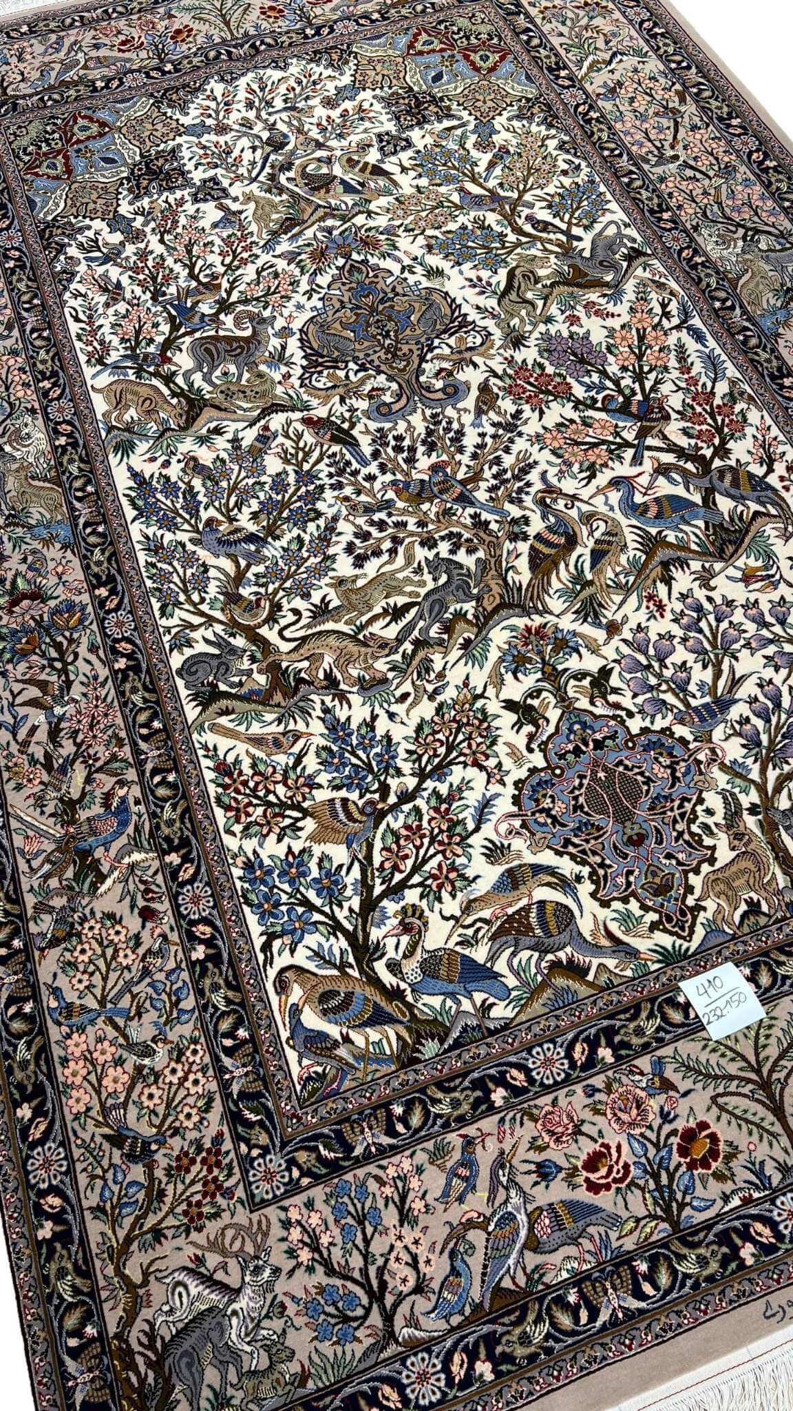 "Traditional Persian hand-knotted carpet with intricate animal motifs, floral patterns, and a luxurious silk warp."
