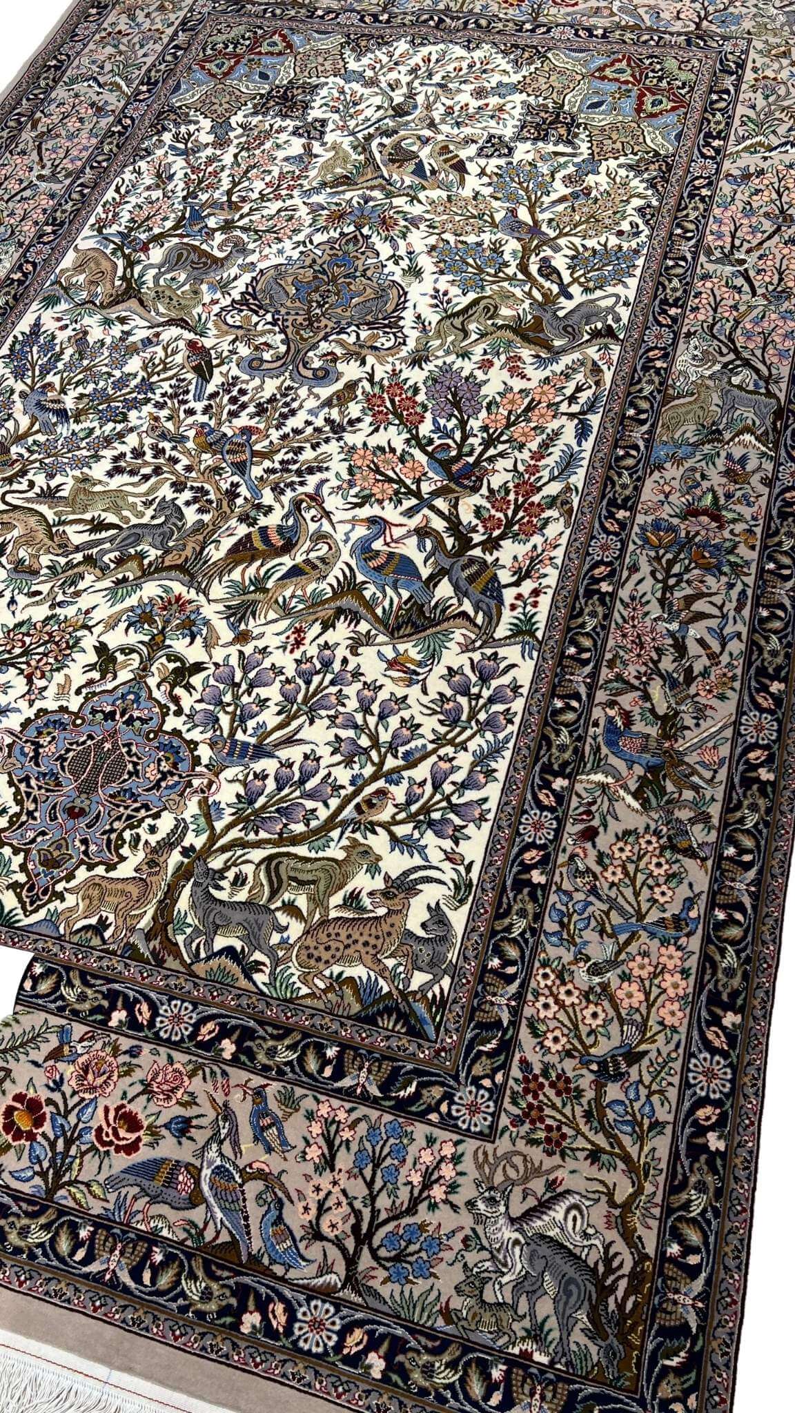 "Handwoven Isfahan Persian rug with silk and wool, showcasing a detailed hunting scene with birds, deer, and floral patterns."