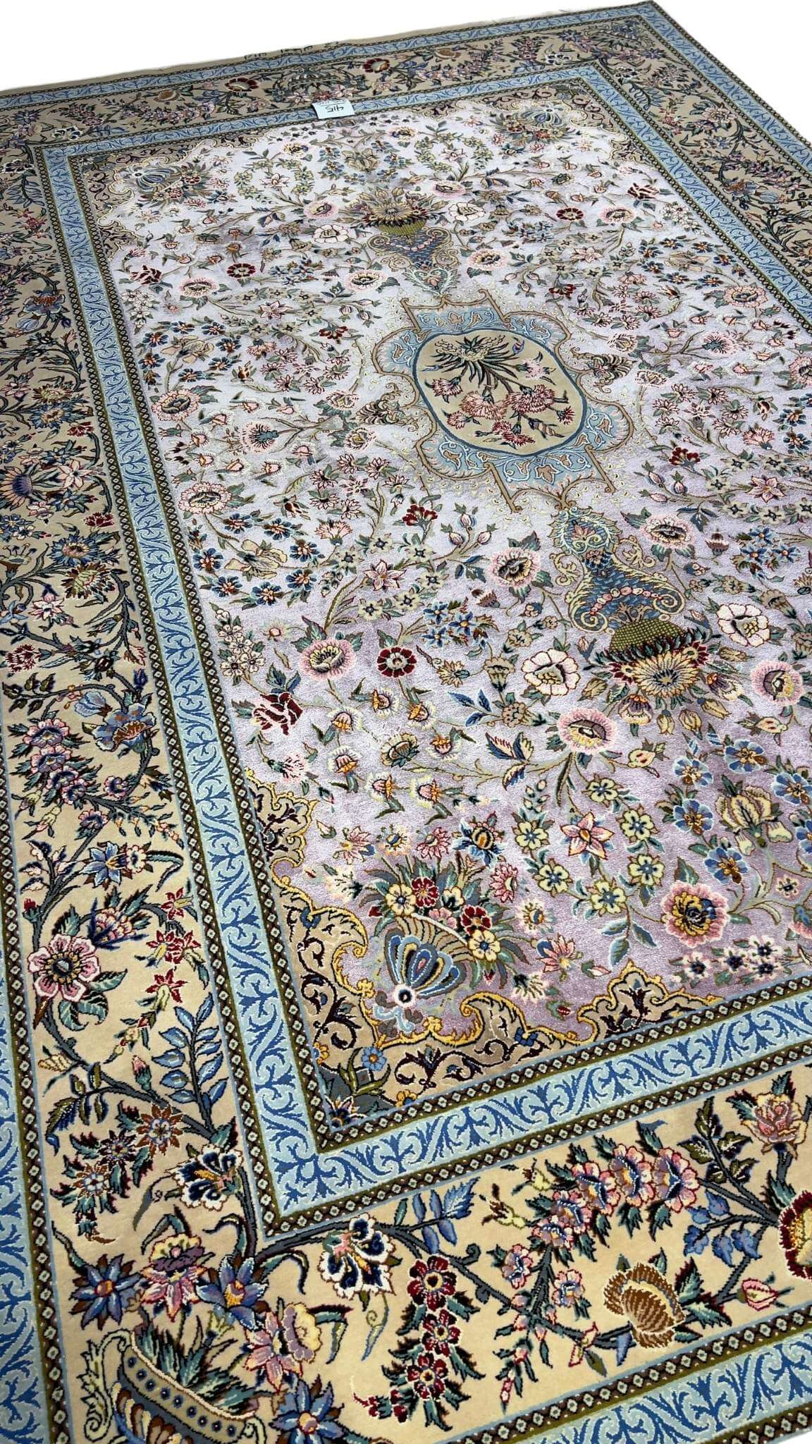 "Handmade Persian Isfahan rug featuring a detailed flower vase design and vibrant blue borders."
