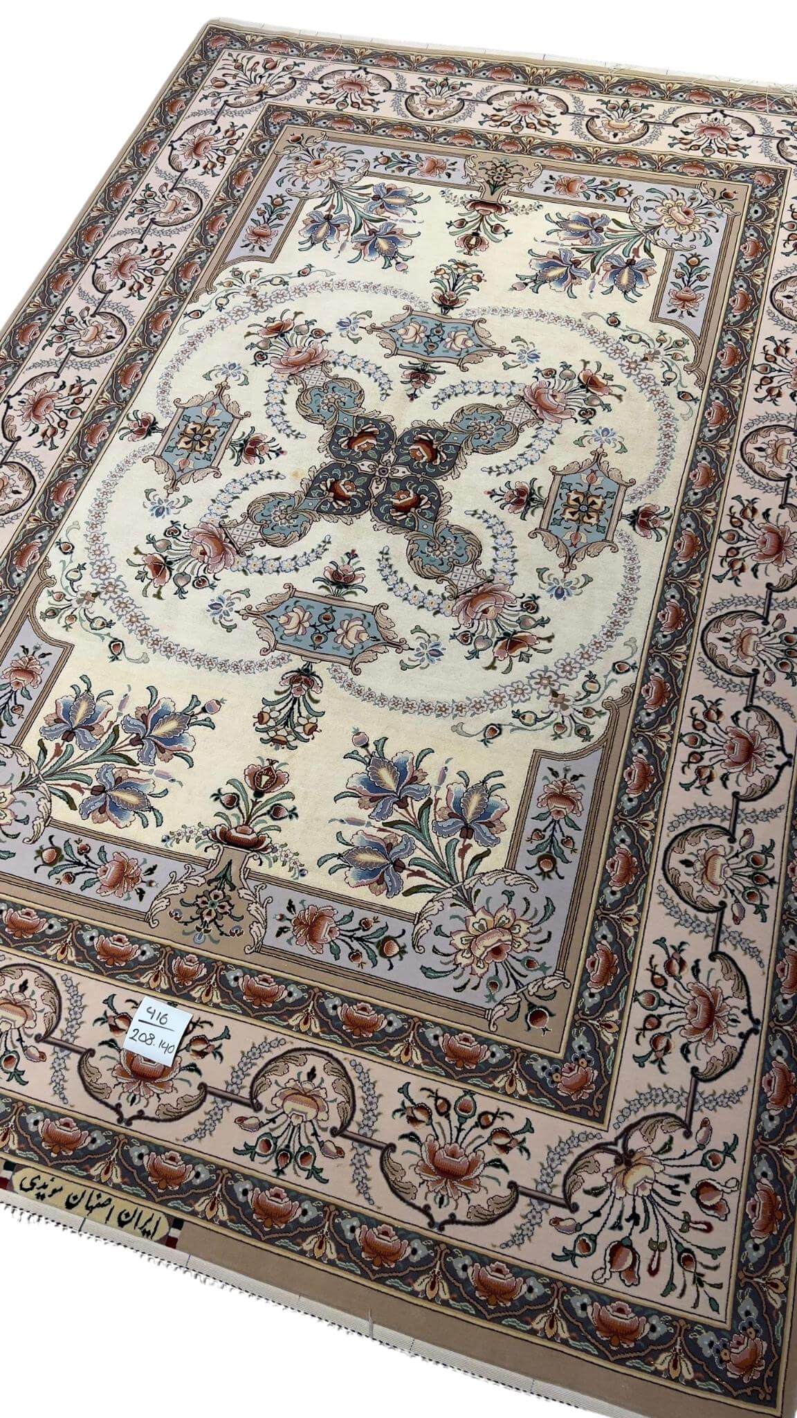 "Luxurious Persian rug featuring a central medallion with pastel-toned floral motifs, crafted in Isfahan, Iran."
