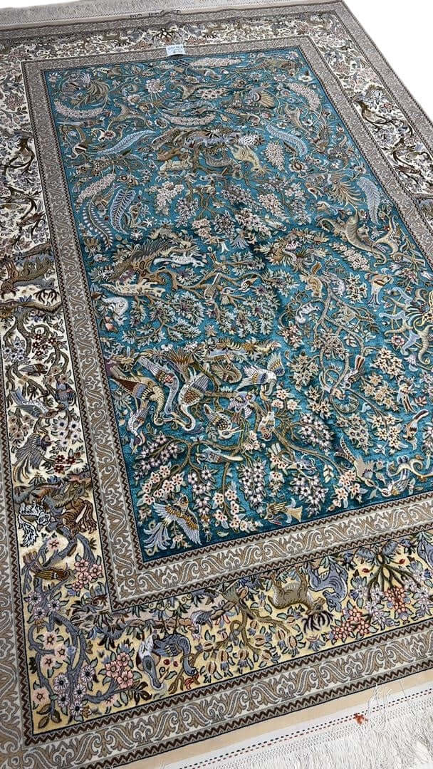 "Handmade Persian carpet from Isfahan – elegant silk and wool area rug with detailed Persian hunting design."