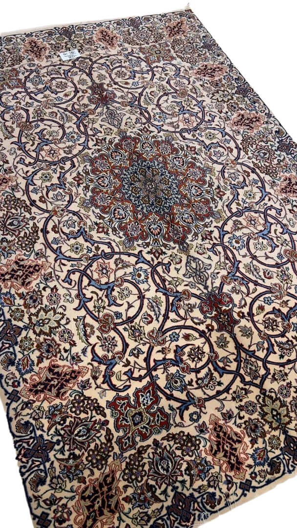 "Hand-knotted 70-year-old Isfahan rug, made with wool and silk."
