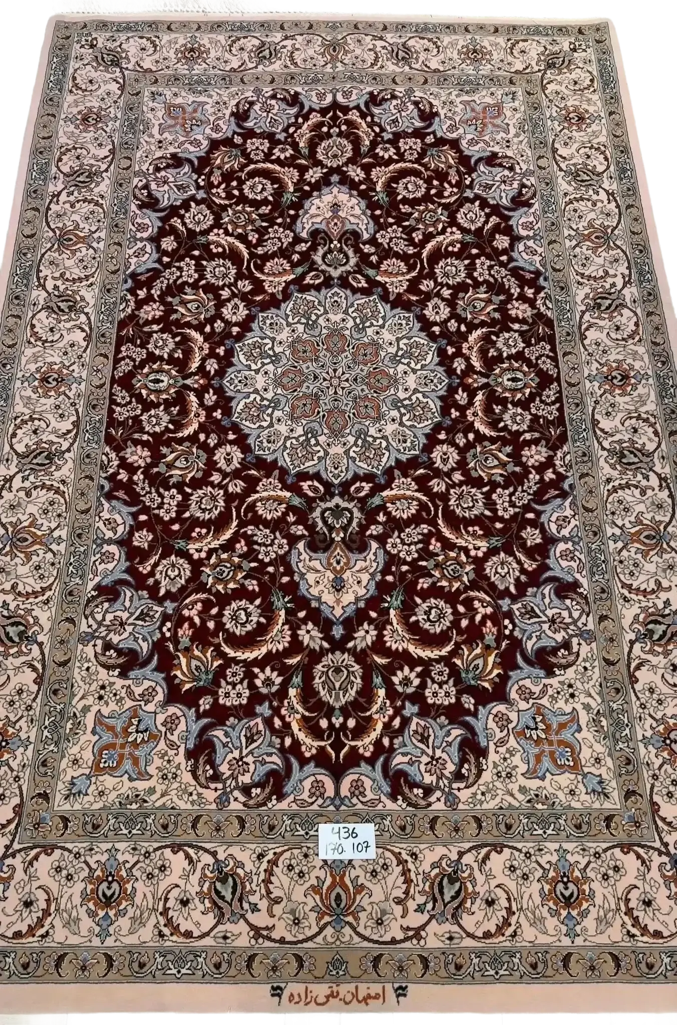 "Hand-knotted luxury Isfahan Persian rug crafted by renowned Taghiezadeh. This exquisite silk and wool Persian rug measures 170 cm x 107 cm (5.6 ft x 3.5 ft), featuring a knot density of 810,000 knots per square meter. Elevate your home decor with this authentic Persian carpet, available online, with only one piece in stock."