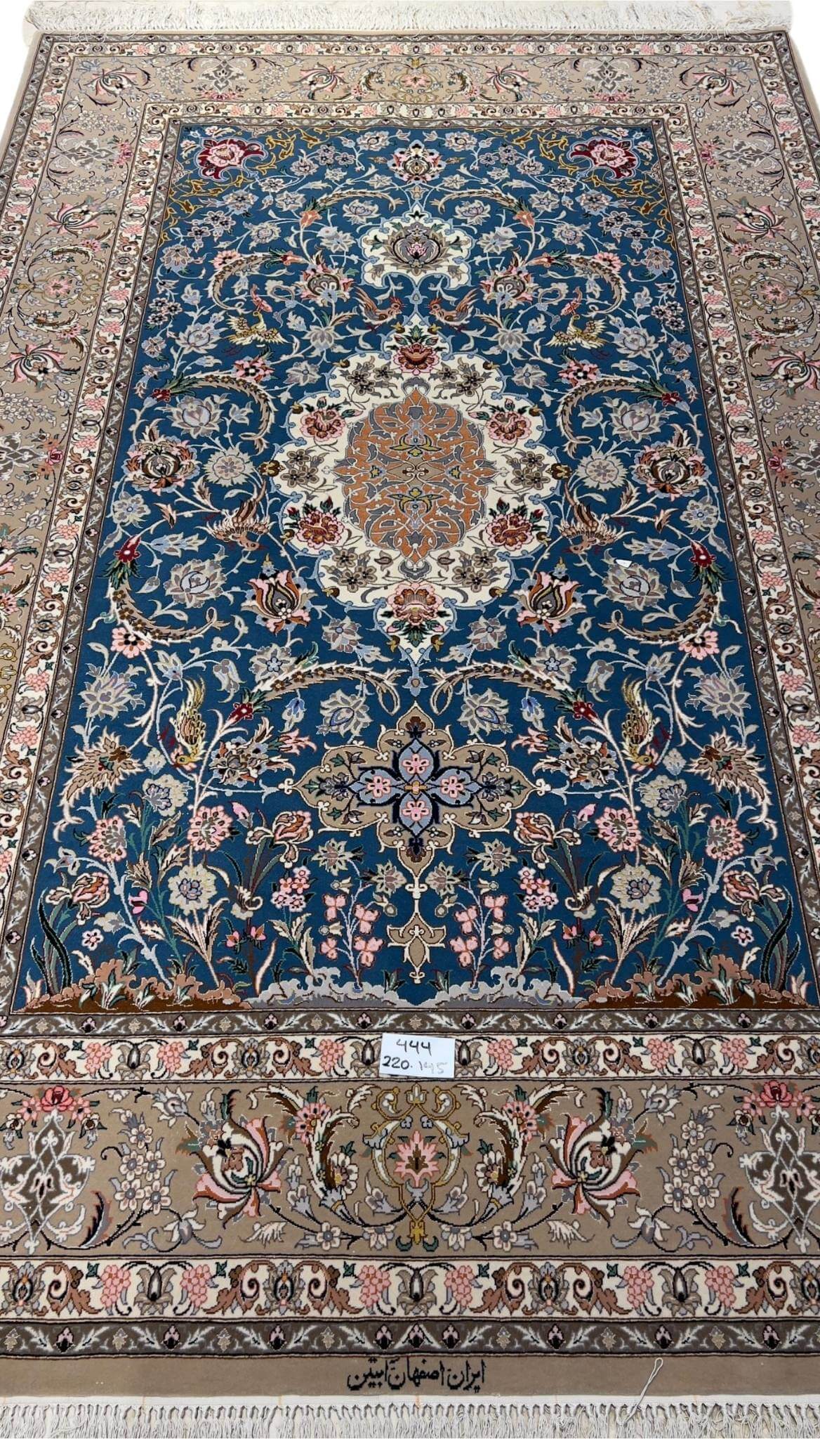 Isfahan hand-knotted rug in blue with a central medallion design.
