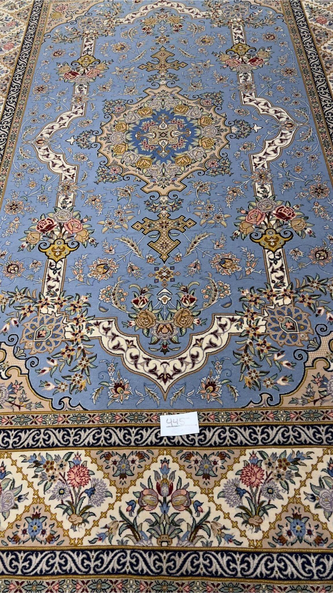"Sky-blue Persian rug with intricate floral and medallion design, hand-knotted by Mansourie, 220 x 150 cm."
