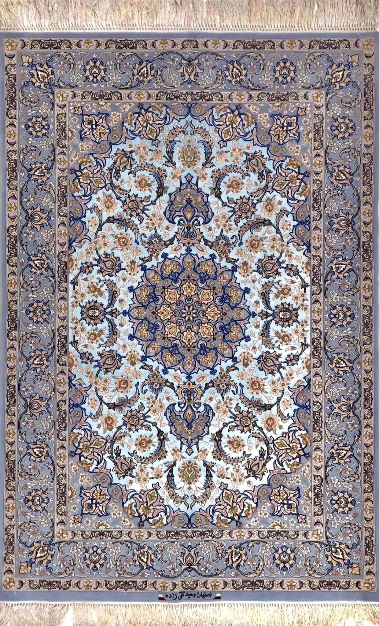 "Handwoven Isfahan Persian rug with intricate medallion design, crafted from silk and wool in soft blue and ivory."