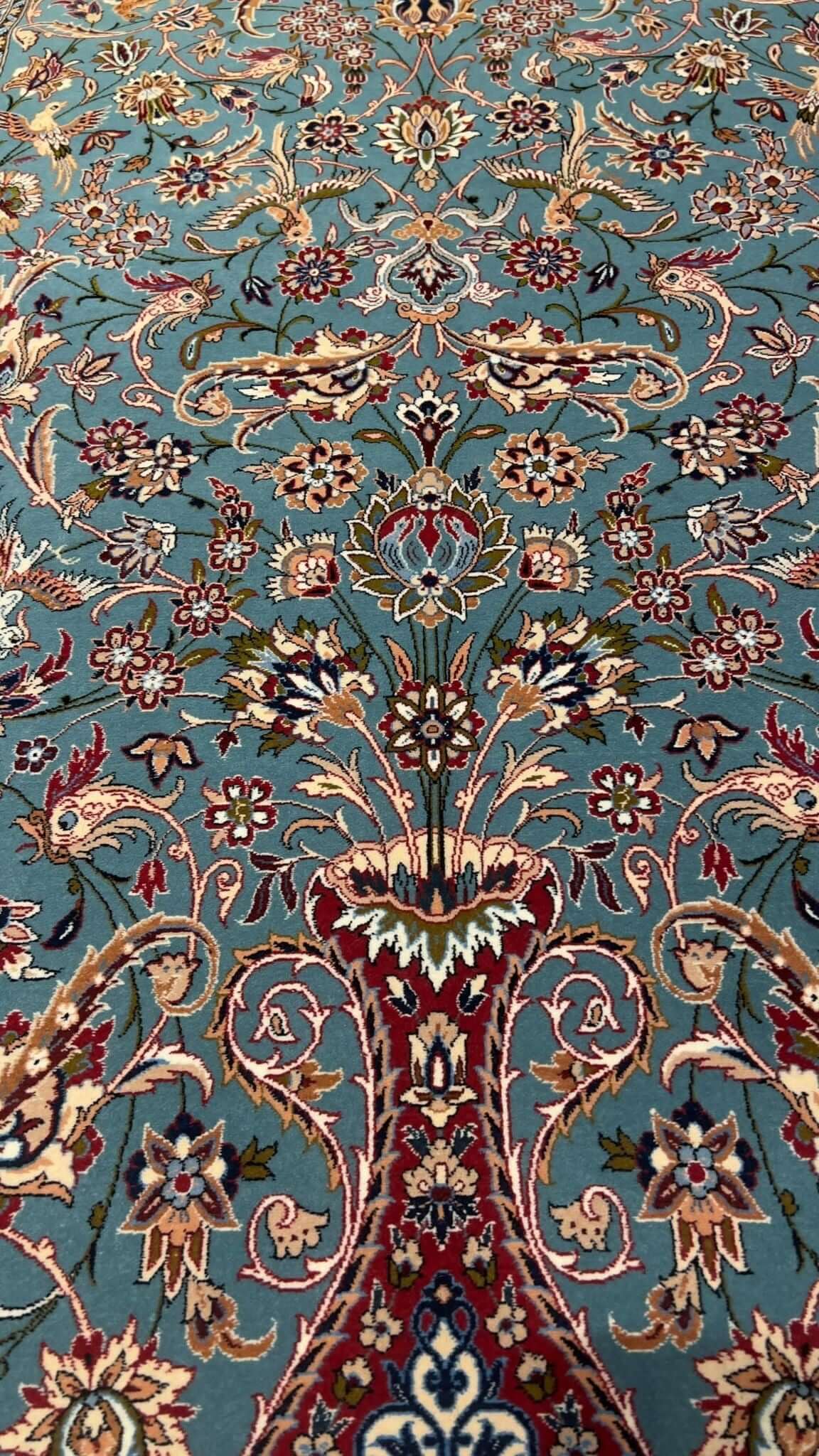 "Light blue Persian rug, 170x110 cm, handmade in Isfahan by Master Zojajie, featuring intricate floral designs and crafted from silk and wool."