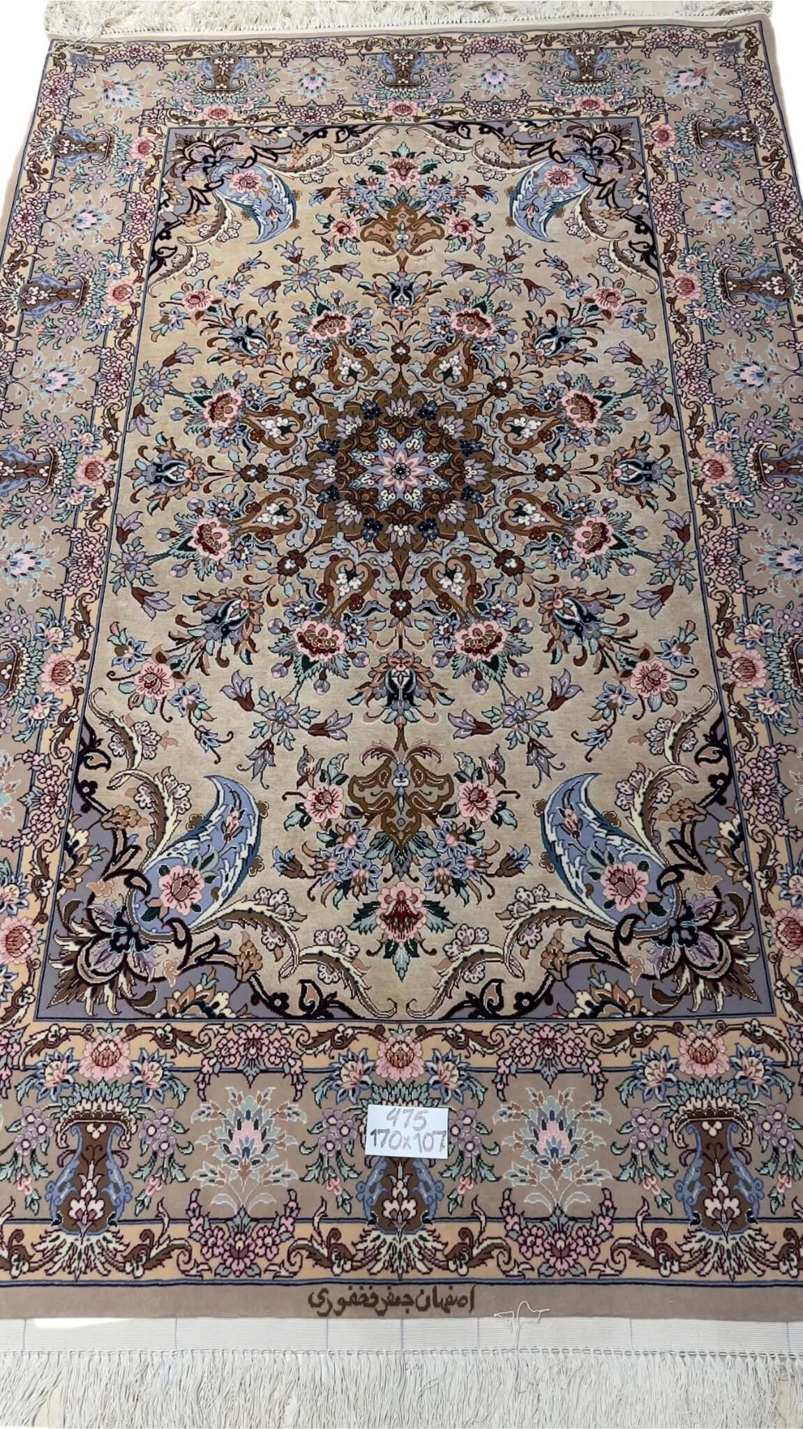 "Hand-knotted traditional Persian rug from Isfahan, made with silk and wool, featuring intricate floral designs in beige and pastel colors, 170x107 cm, crafted by Fakhforie."

